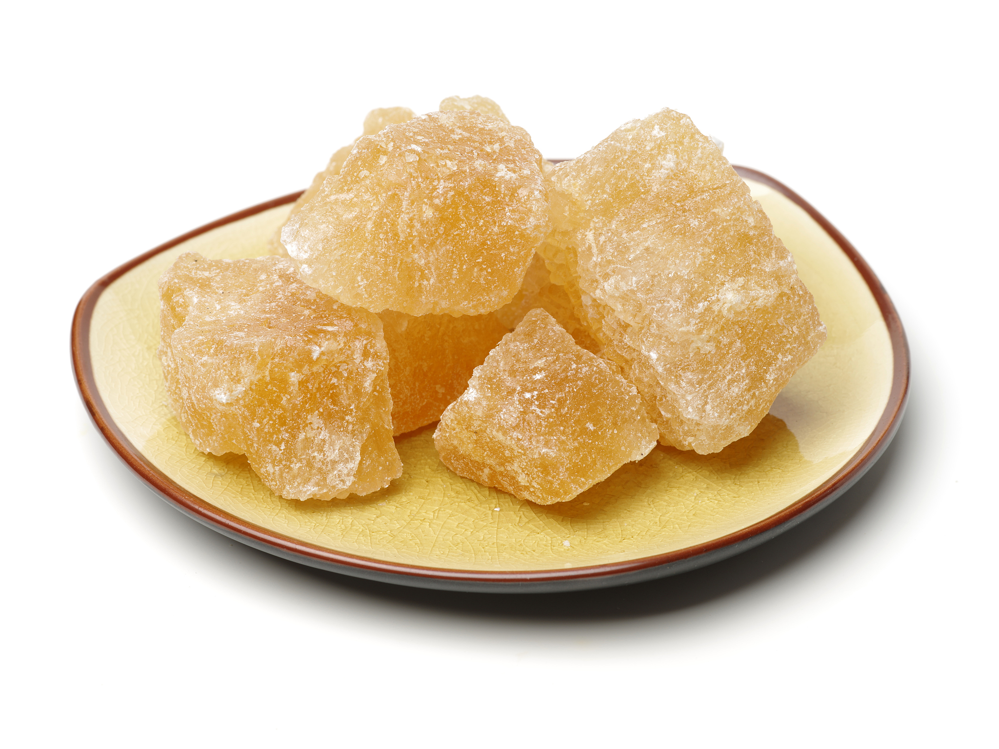 brown crystal sugar on white background