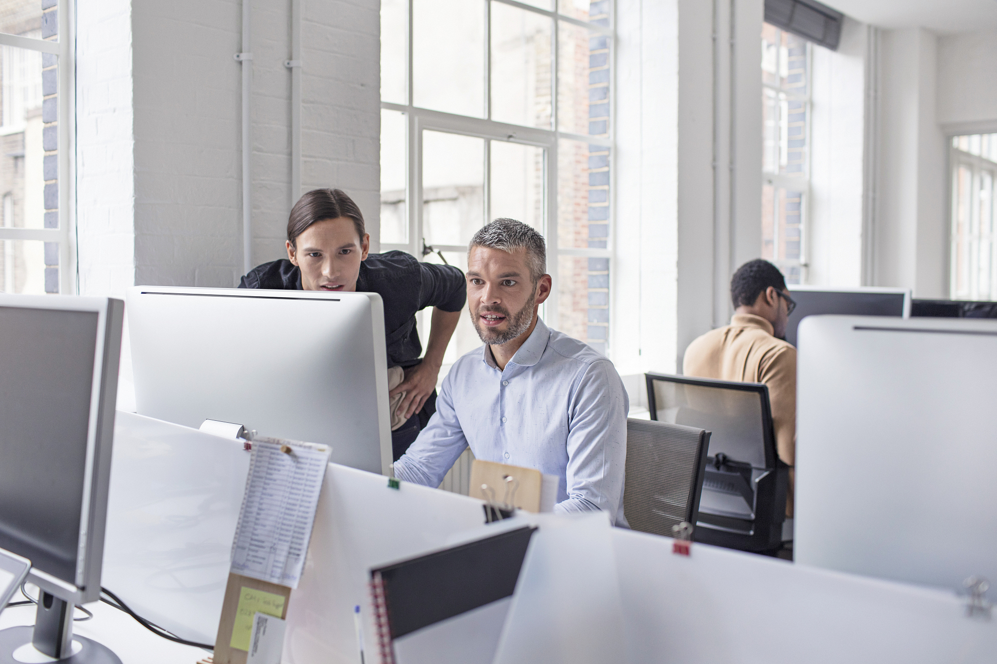 businessmen using computer in new office