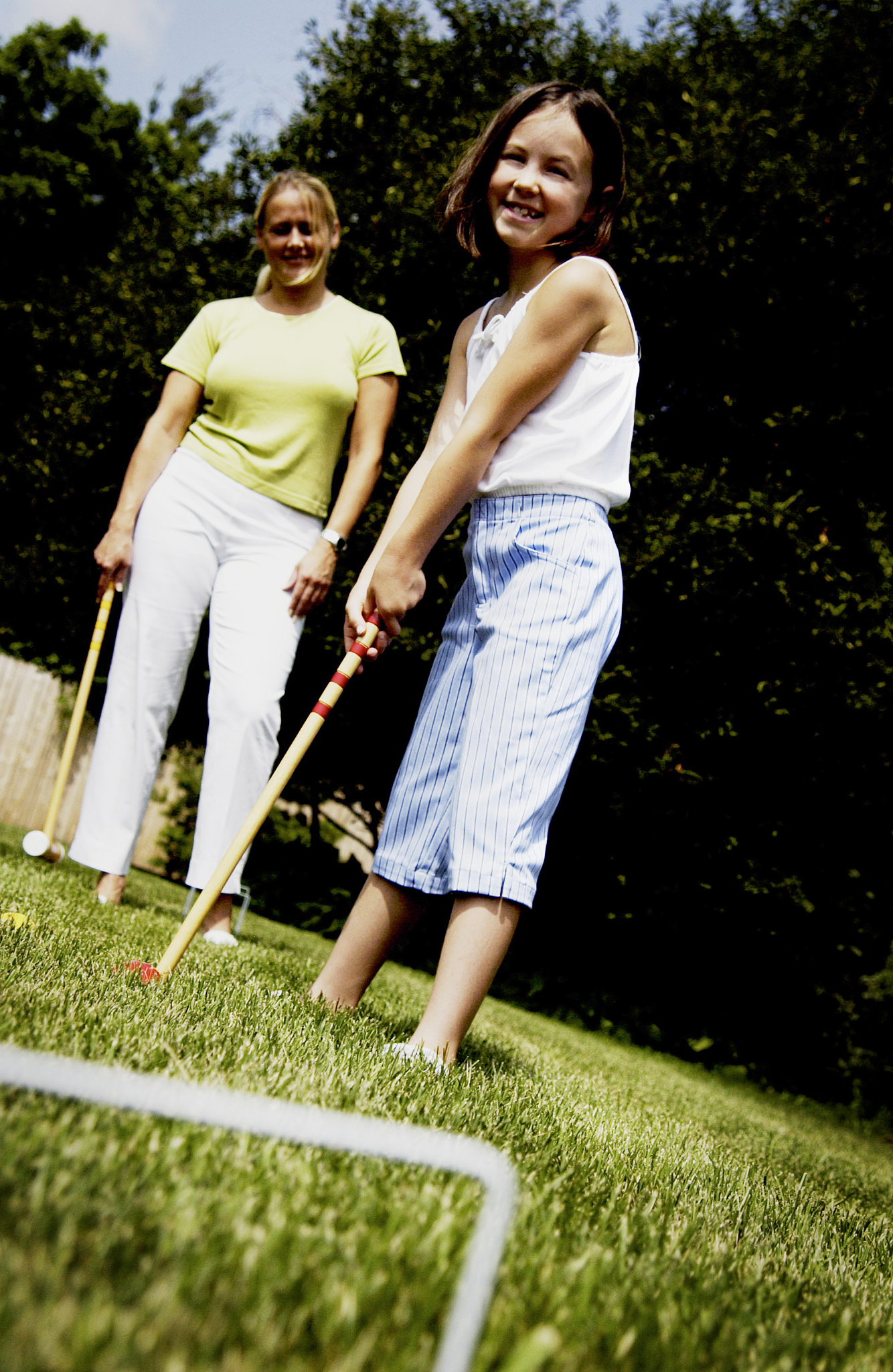 mom and daughter playing croquet