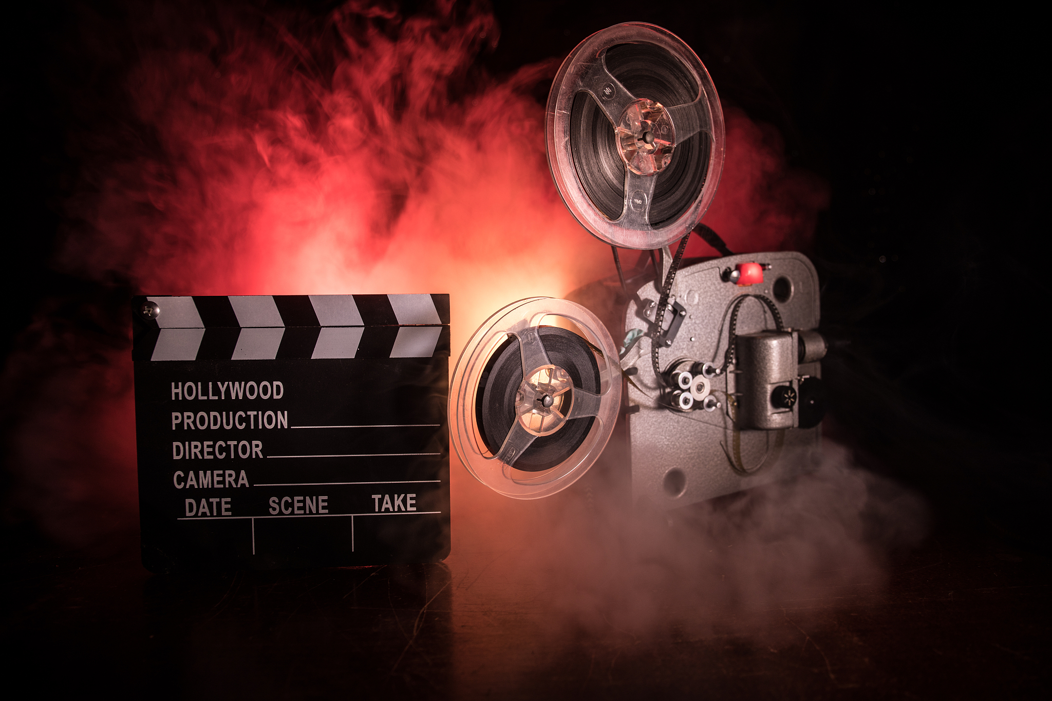 old vintage movie projector on a dark background with fog and li