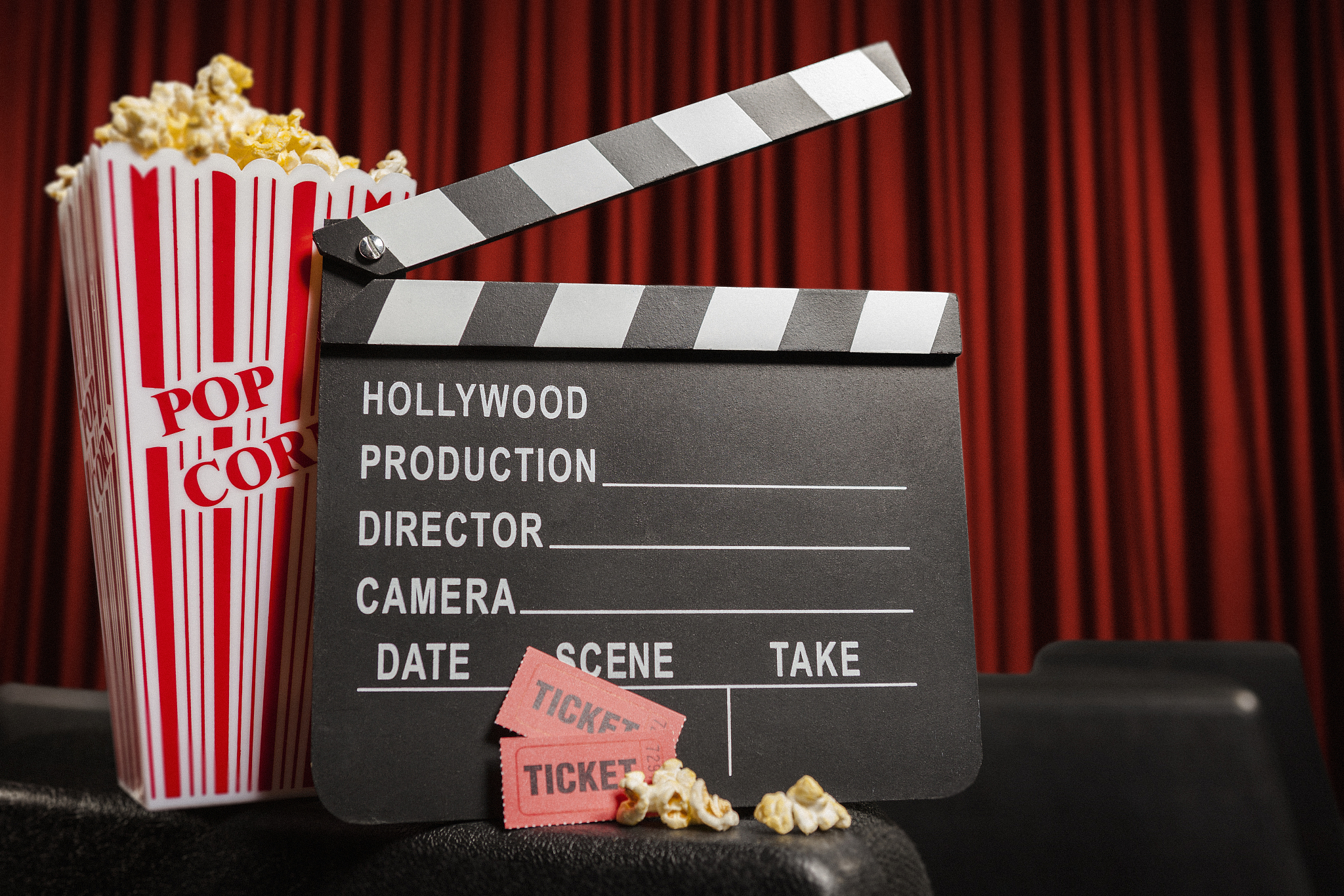 movie theatre with popcorn, tickets and film slate