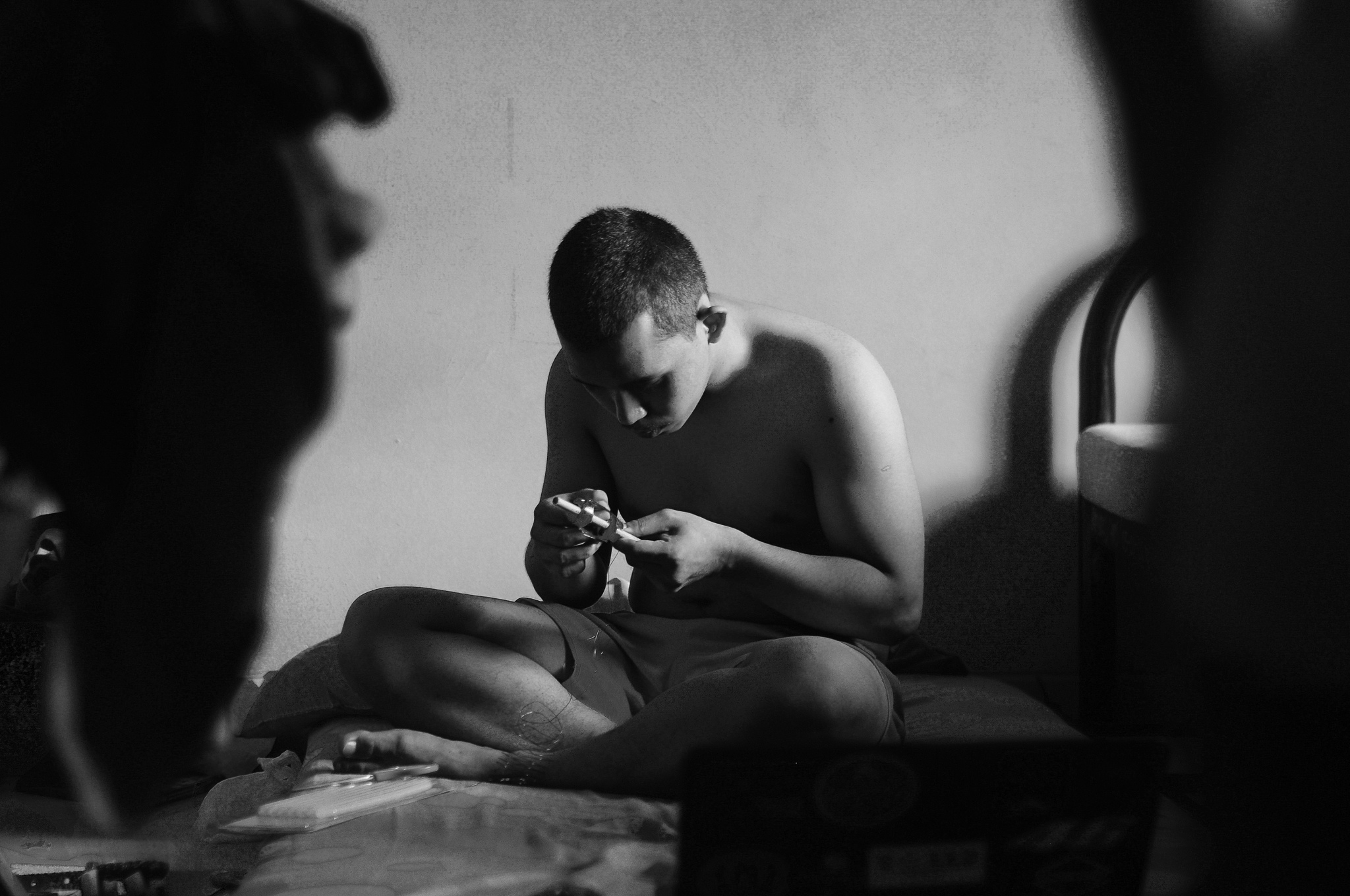 shirtless man working at workshop