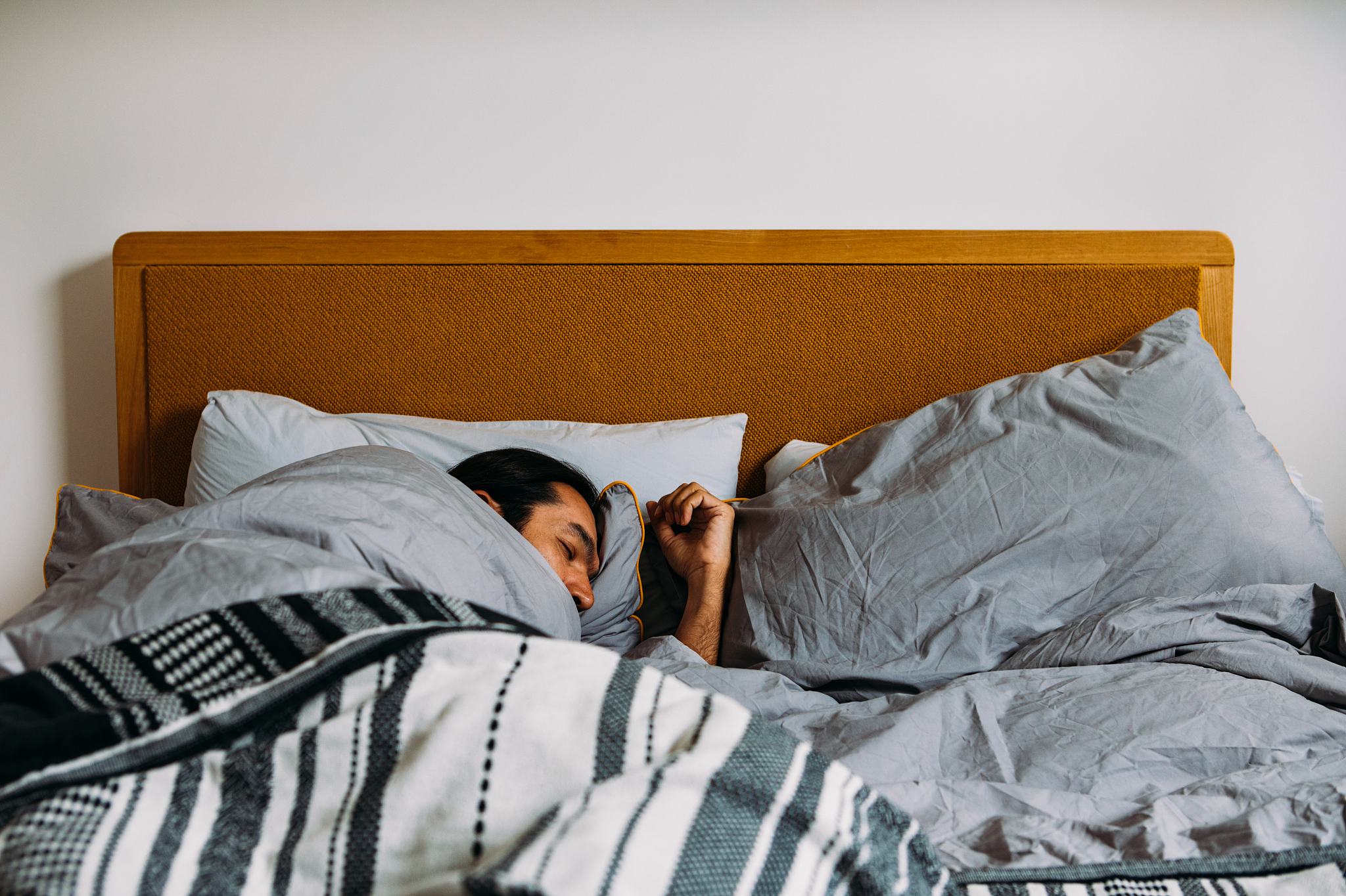 a man sleeping in bed at day time