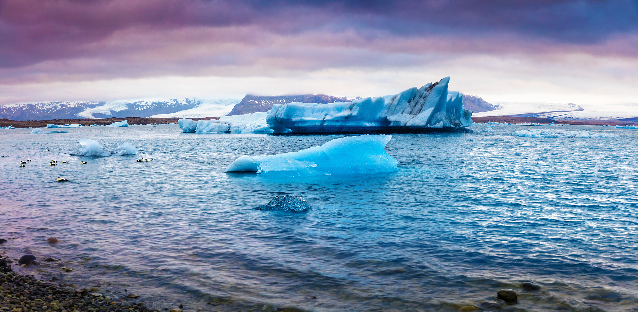 panorama of floating of blue icebergs in jokulsarlon glacial lag
