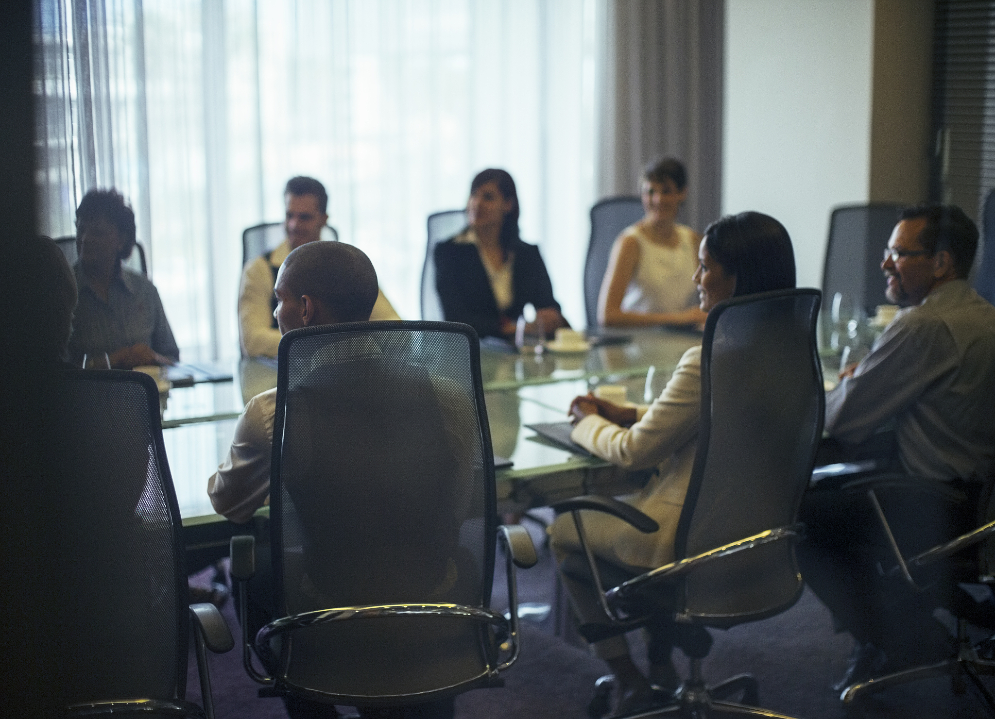 business people attending meeting in conference room