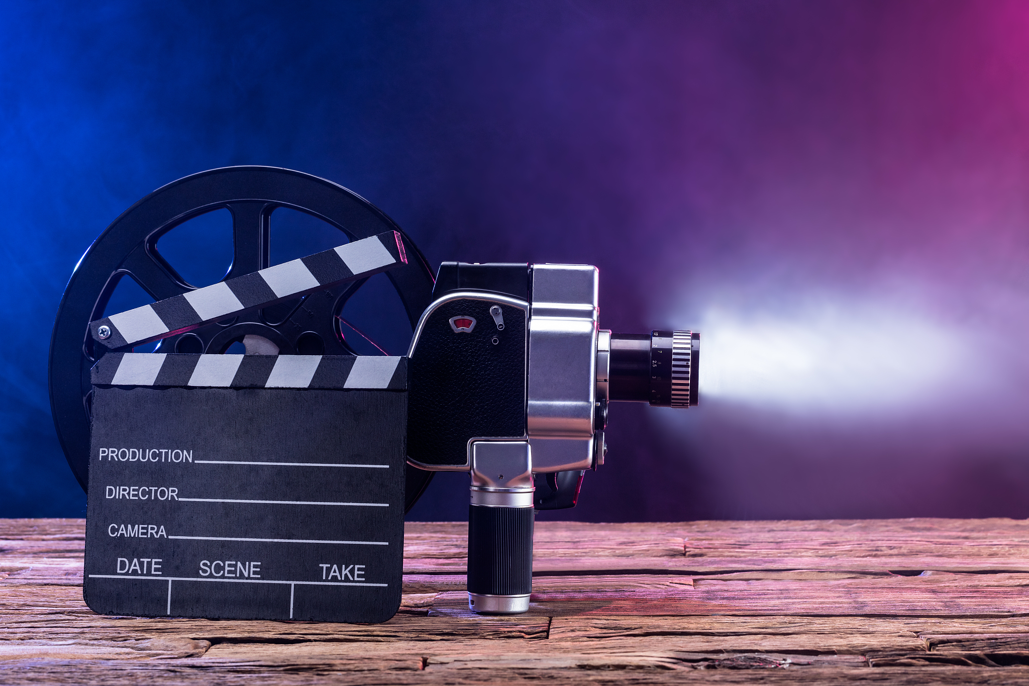 close-up of movie camera with film reel and clapper board