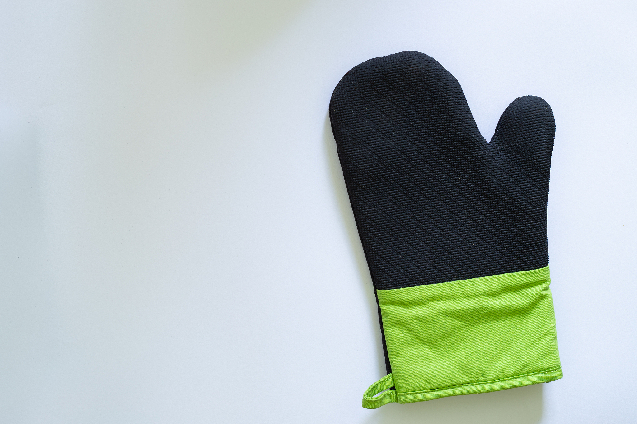 top view of rubber oven glove on white background