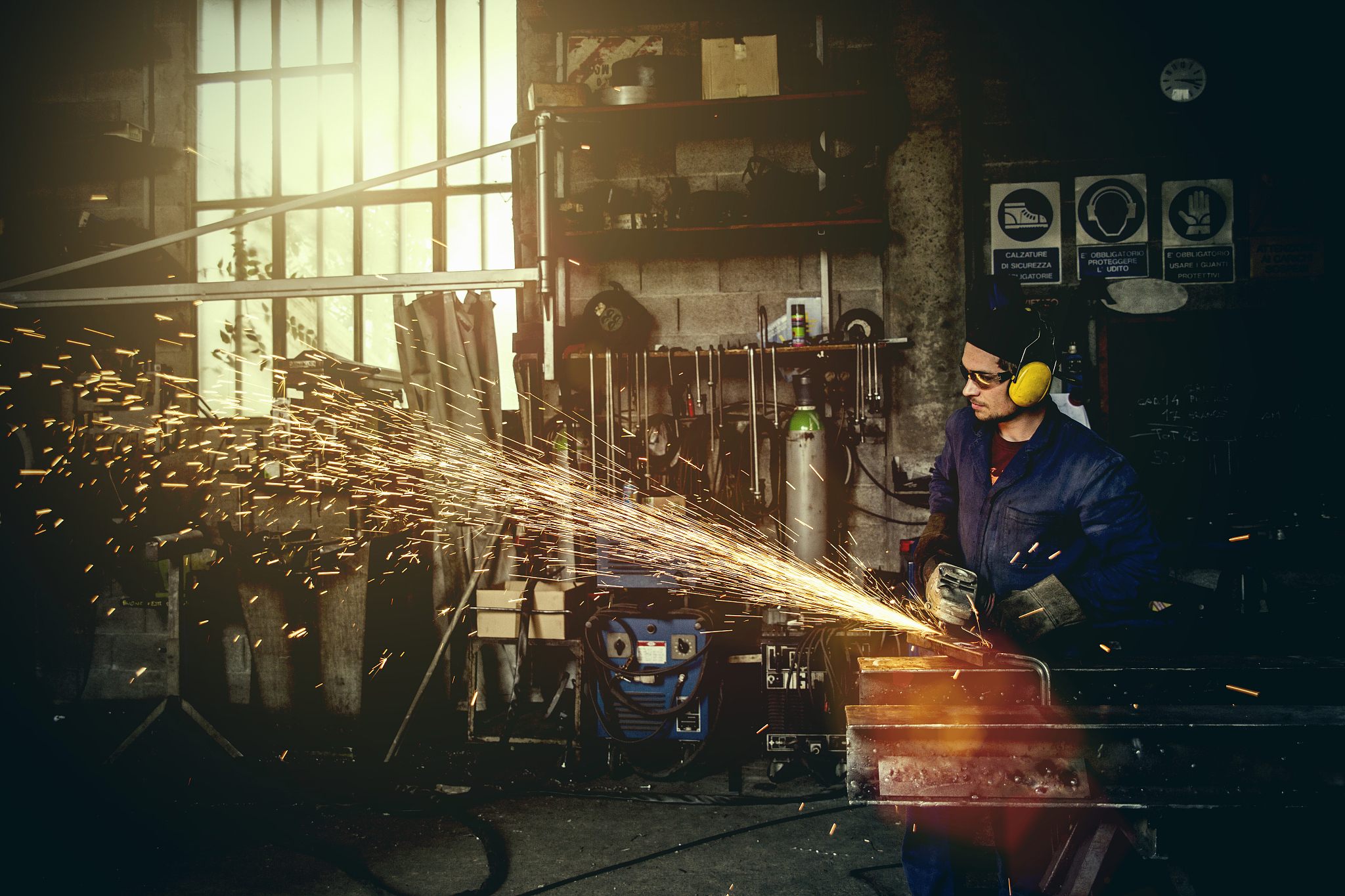 welder cutting iron in workshop