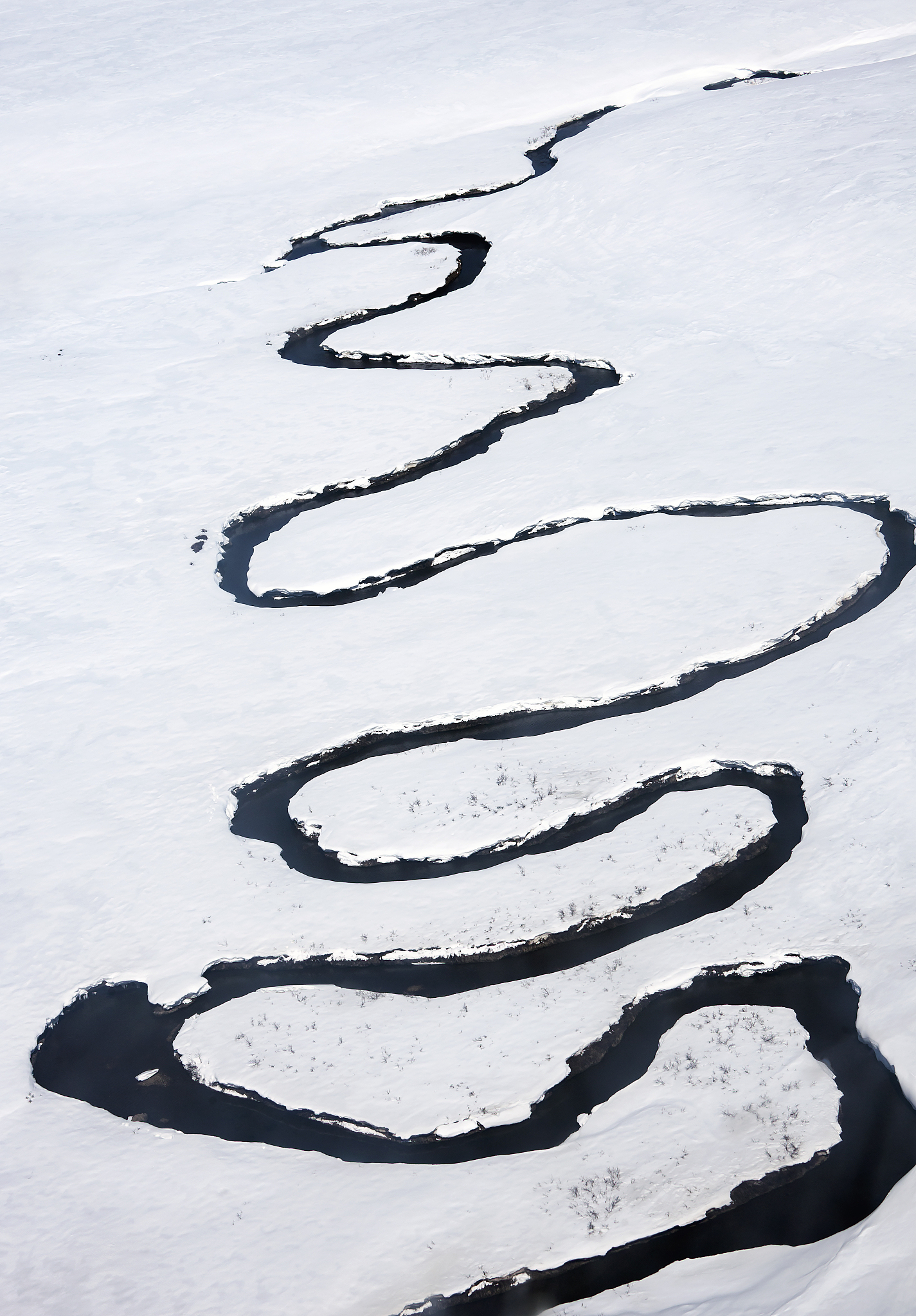 river meanders in the mountain tundra against the background of 