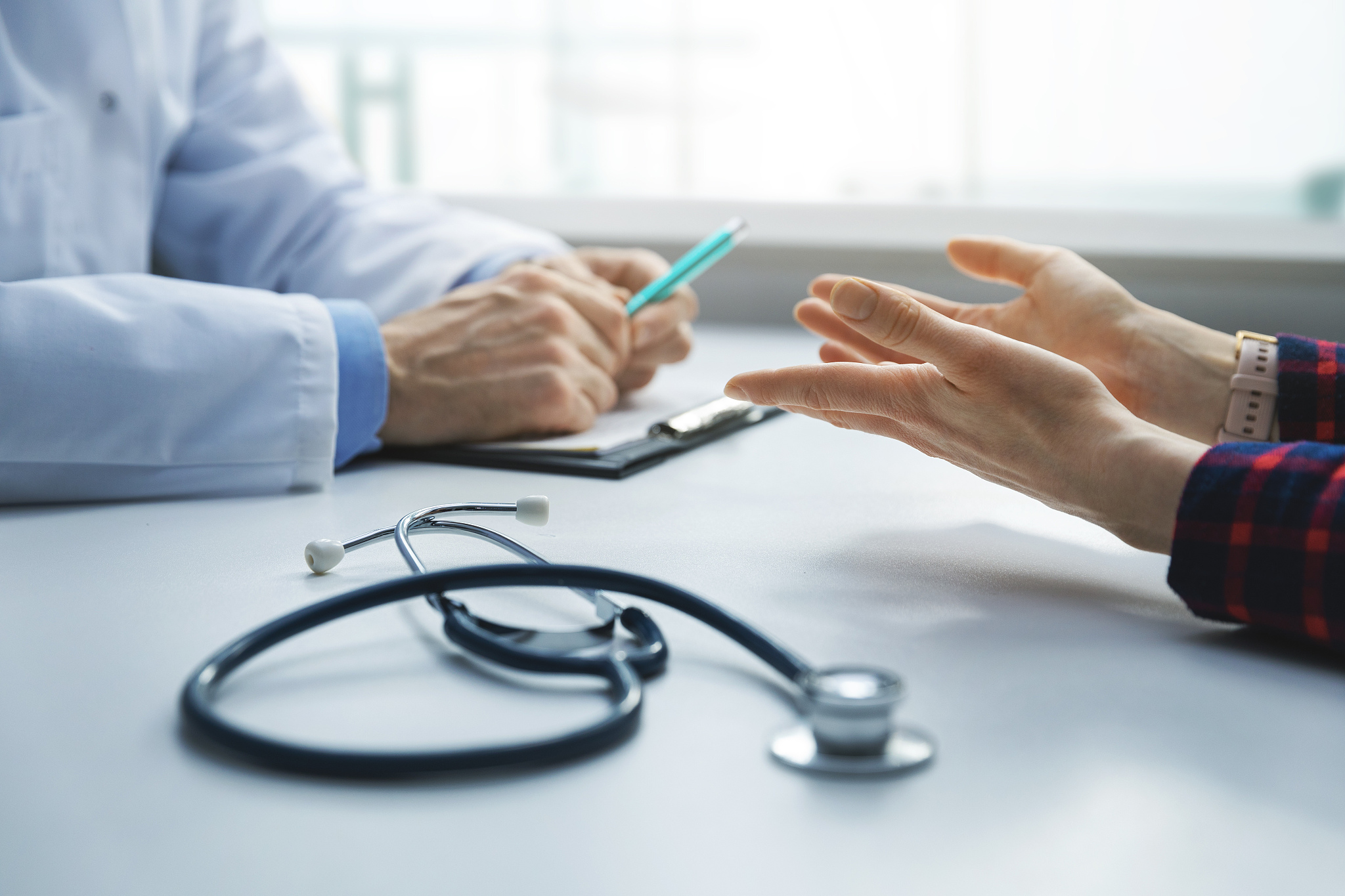 medical consultation - patient in clinic office asks the doctor 