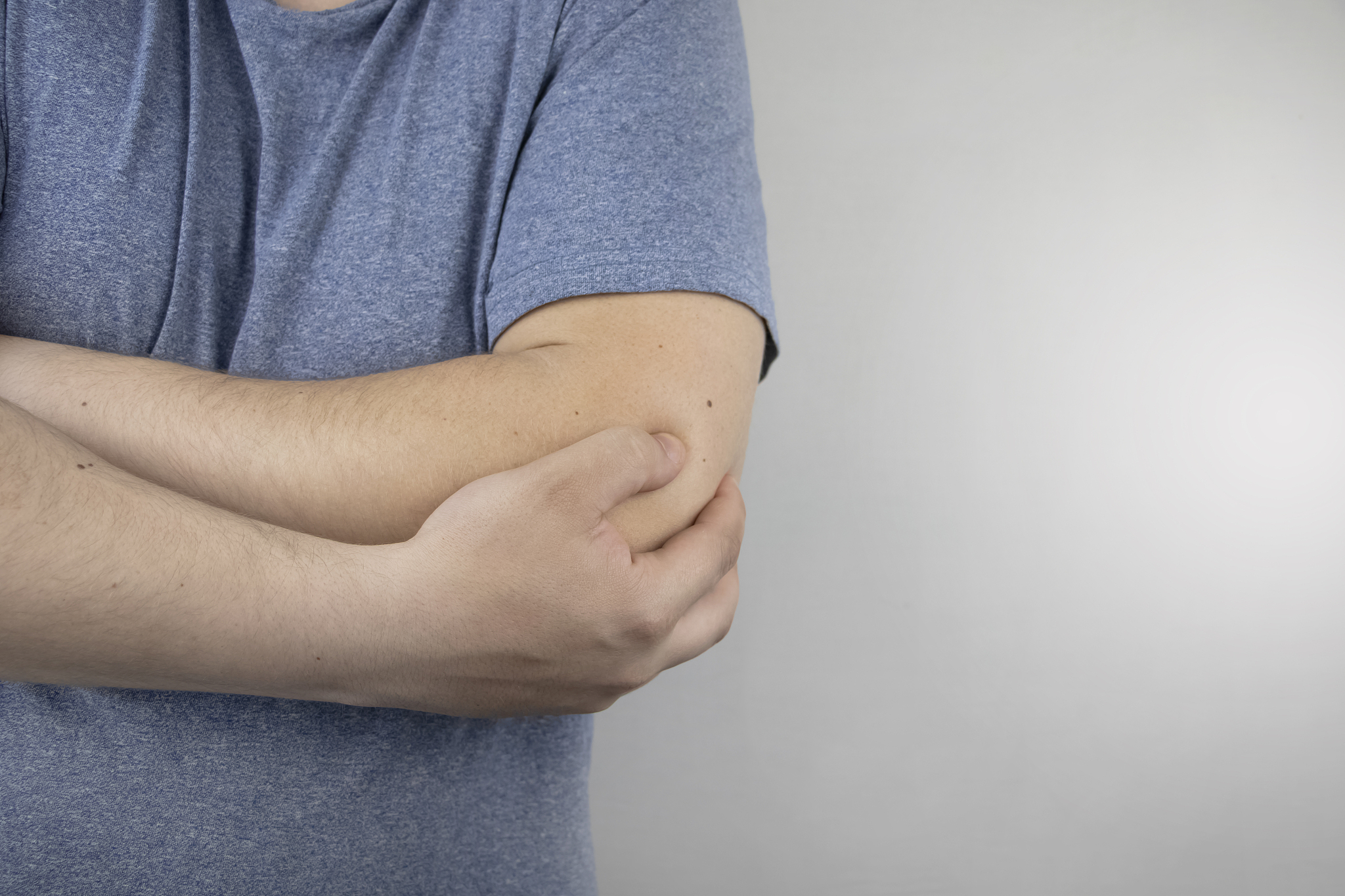 a man suffers from elbow pain. damaged elbow joint, bone fractur