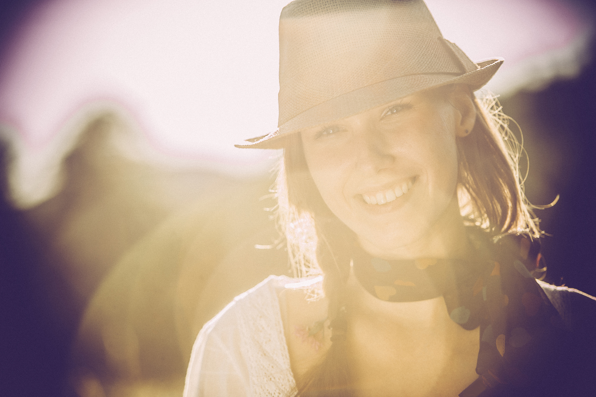 beautiful young woman portrait smiling, against sun