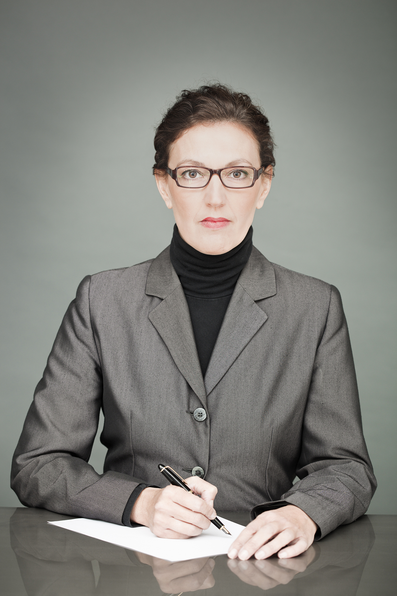 one sophisticated corporate bussines woman signing a document.