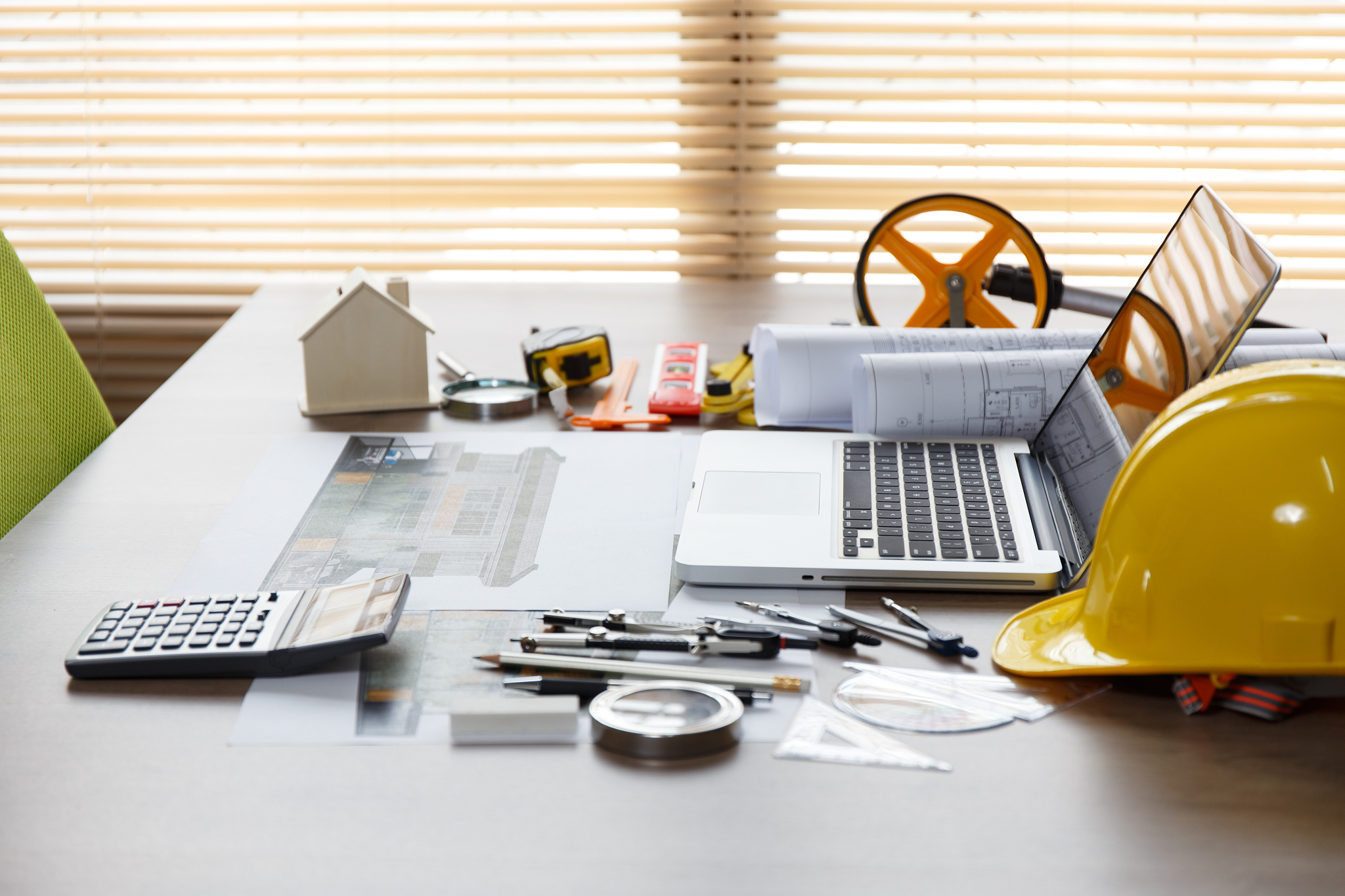 architectural plan, laptop, dividers ,pencil ,pen ,ruler, glasse