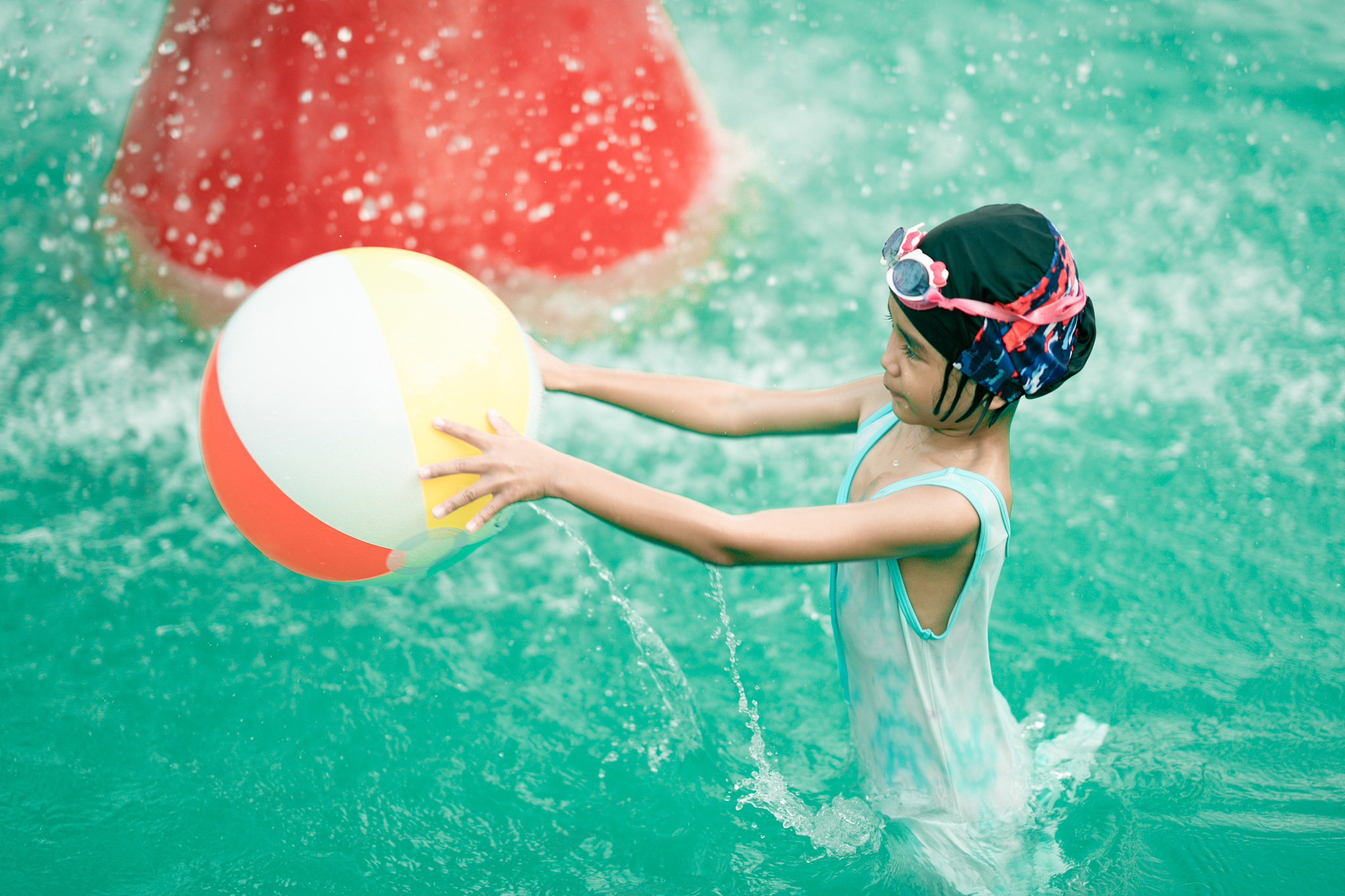 happy kids playing and swimming in swimming pool on summer holid