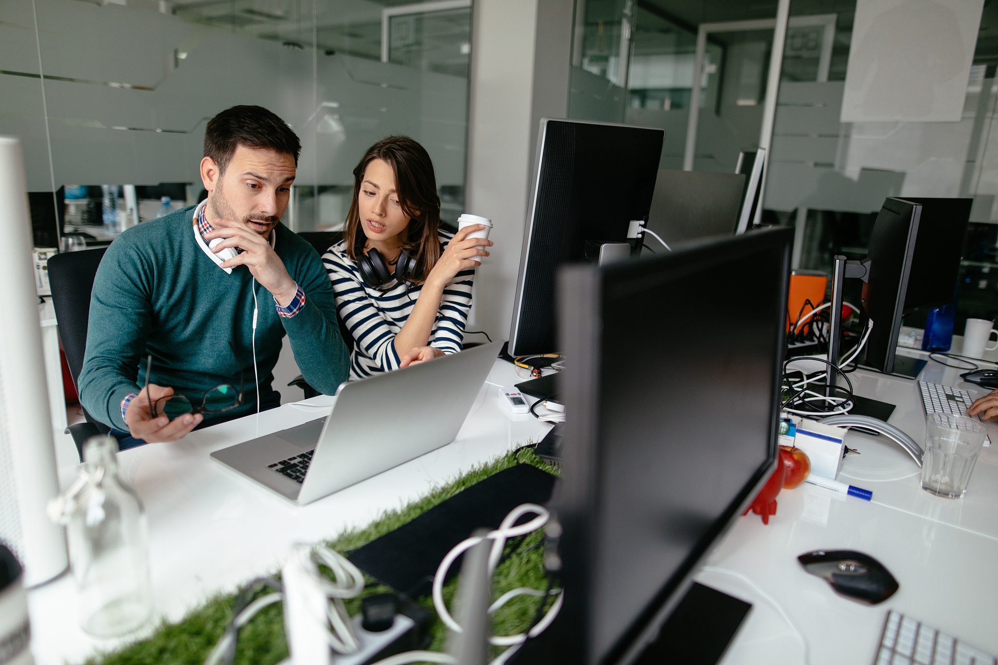 two web designers working in office on a project together