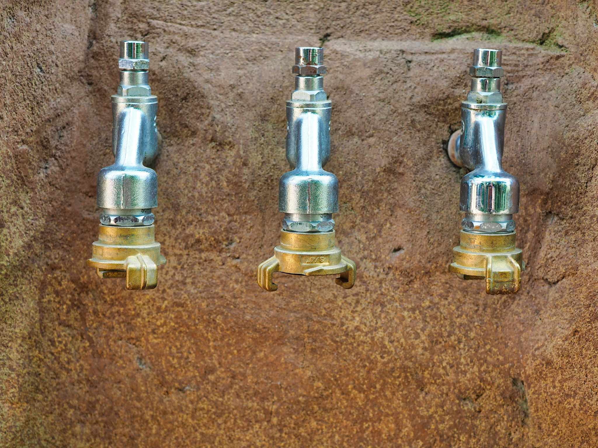close-up of faucet on rock