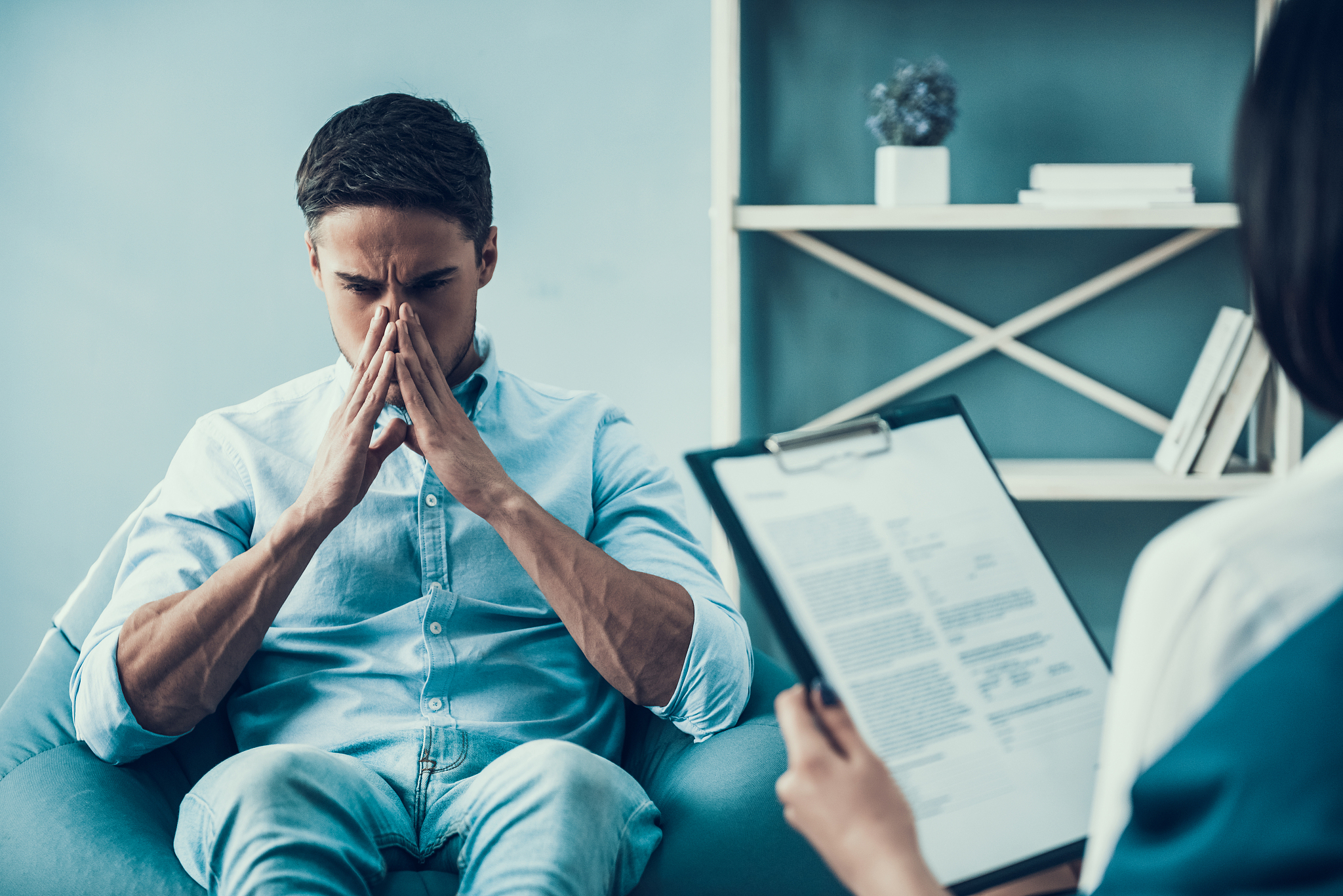 young upset man at psychologist reception.