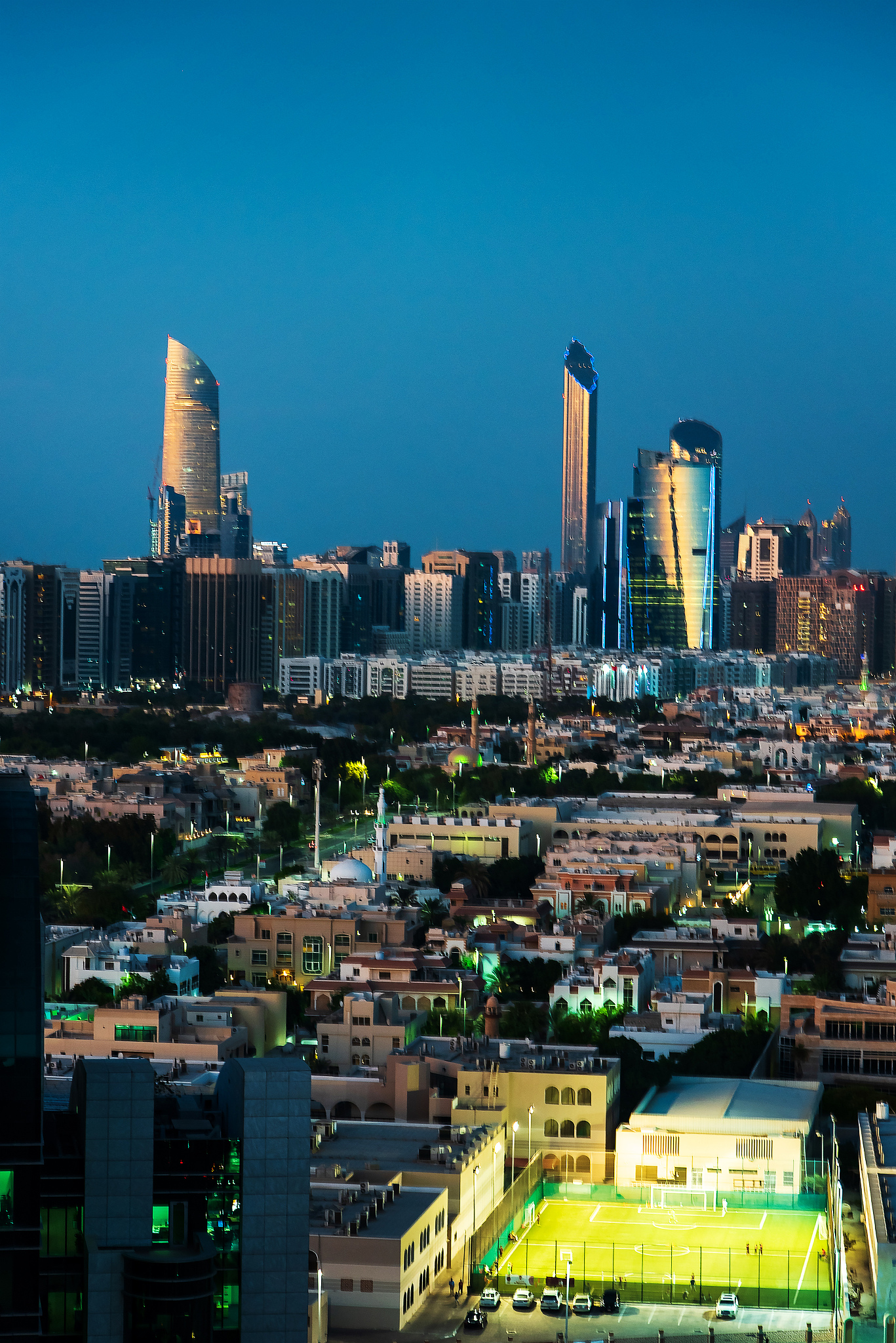 abu dhabi skyline view of modern buildings at blue hour