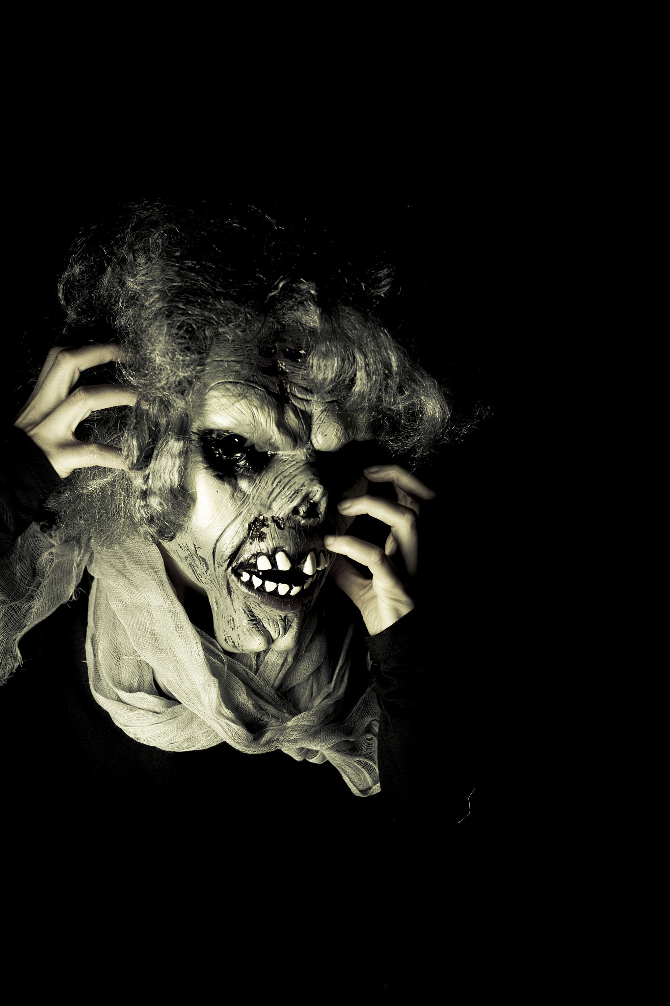portrait of person in evil mask in darkroom