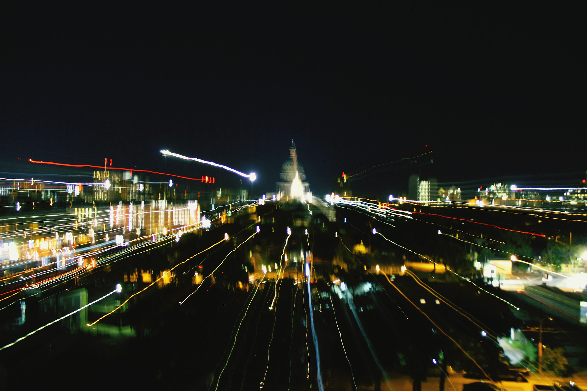 high angle view of light trails on city street against clear sky