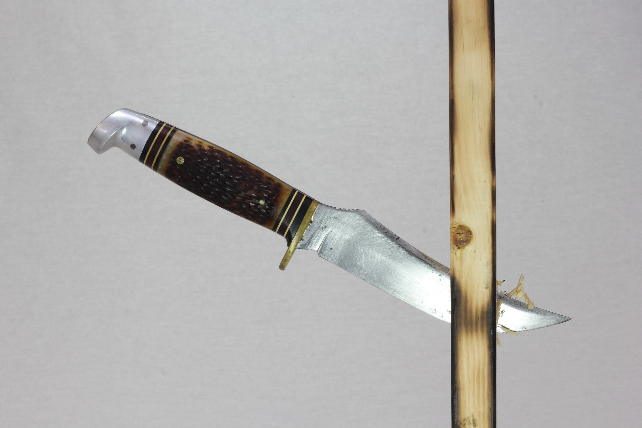 hunting knife stuck in a board