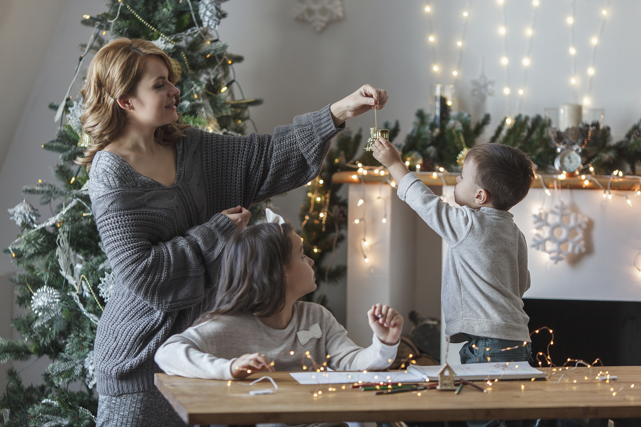 playful woman with children at home during christmas