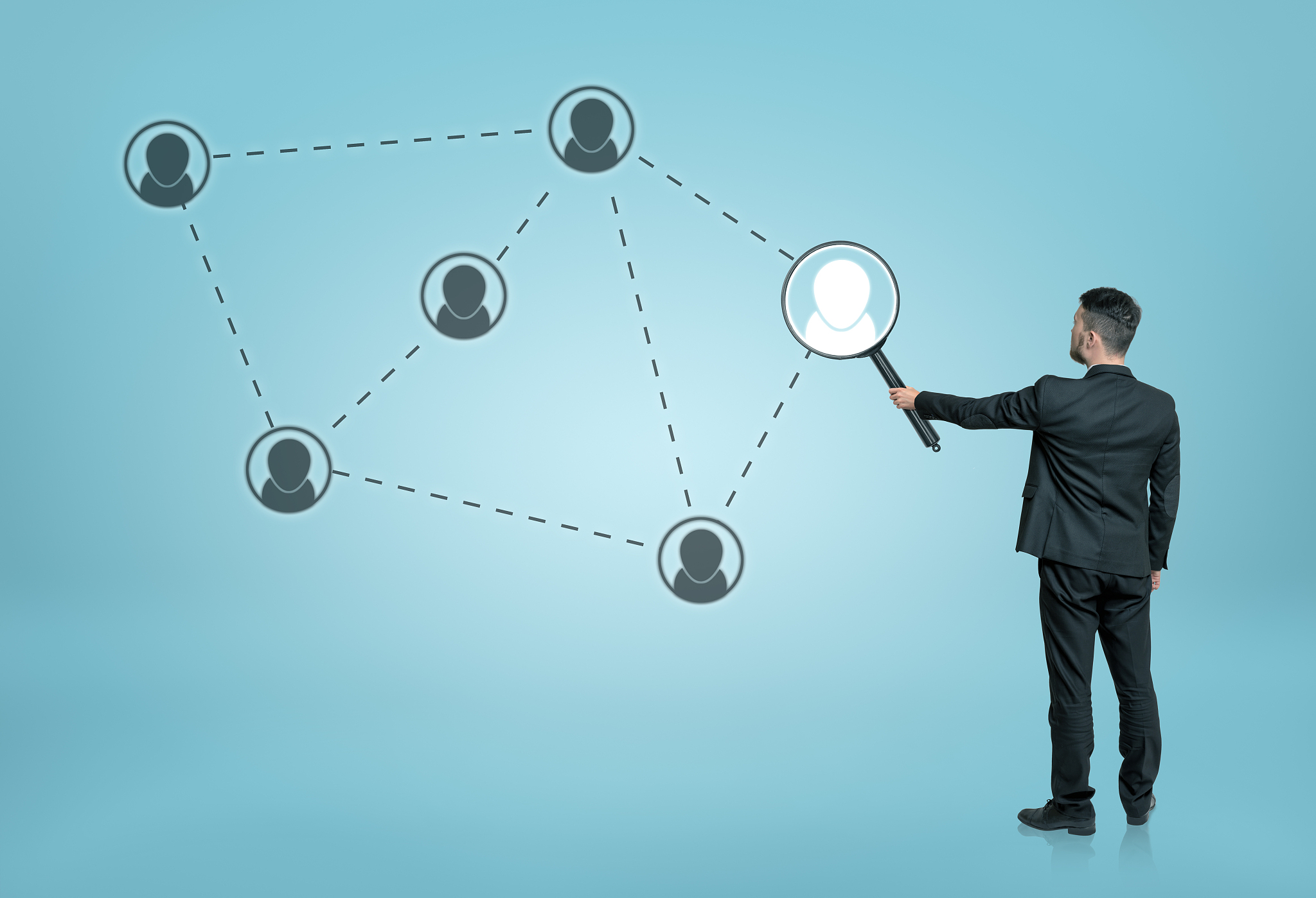 businessman enlarging one of the social network icons connected 