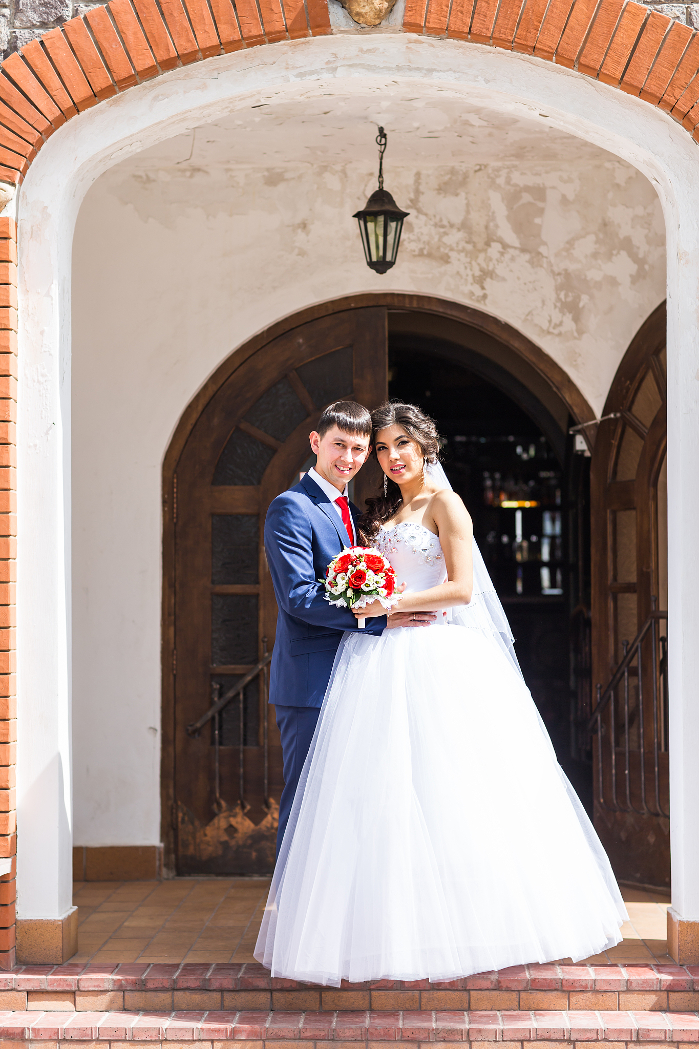 bride and groom at wedding day walking outdoors. happy newlyweds