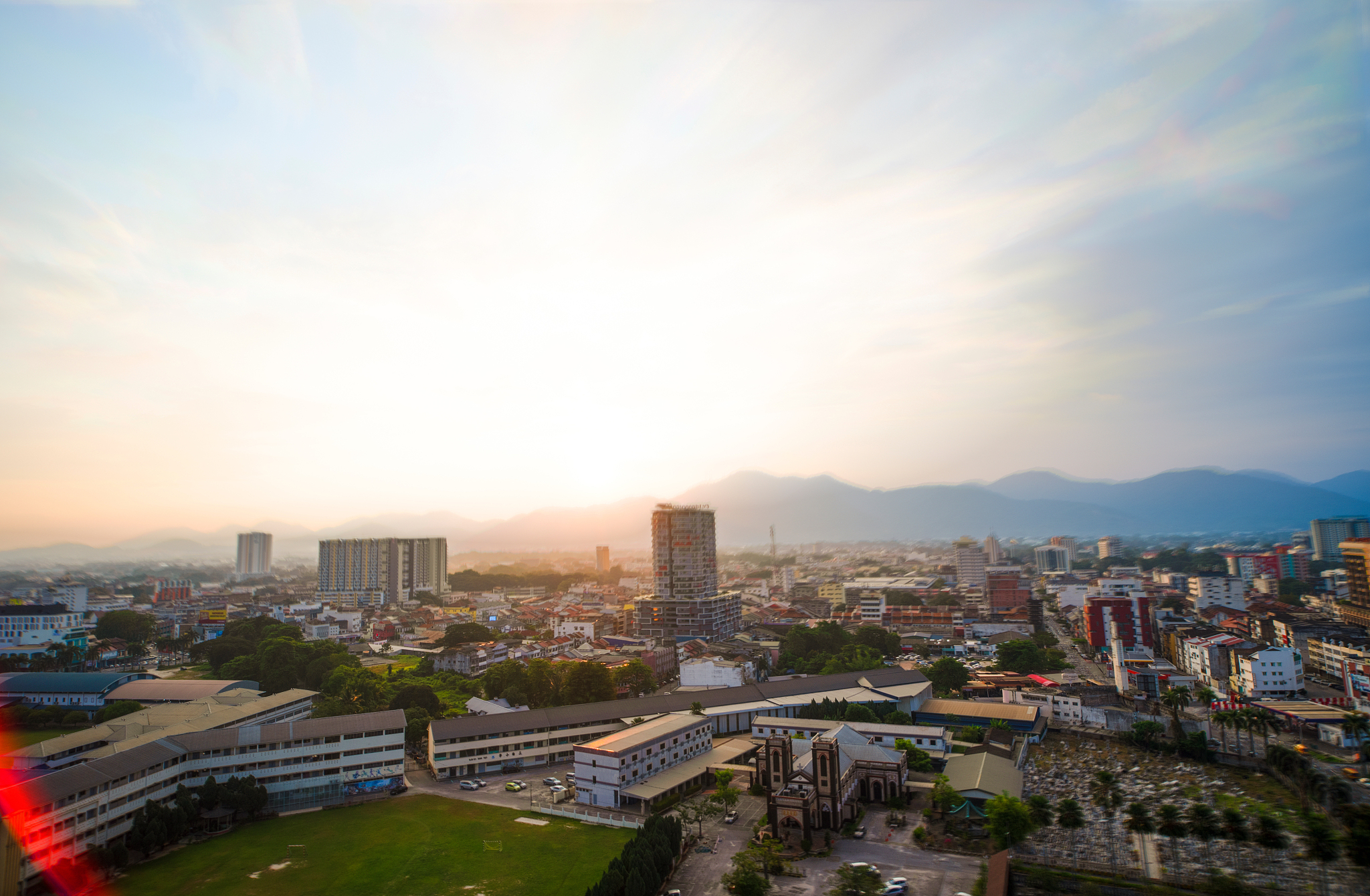 high angle view of buildings against sky during sunset