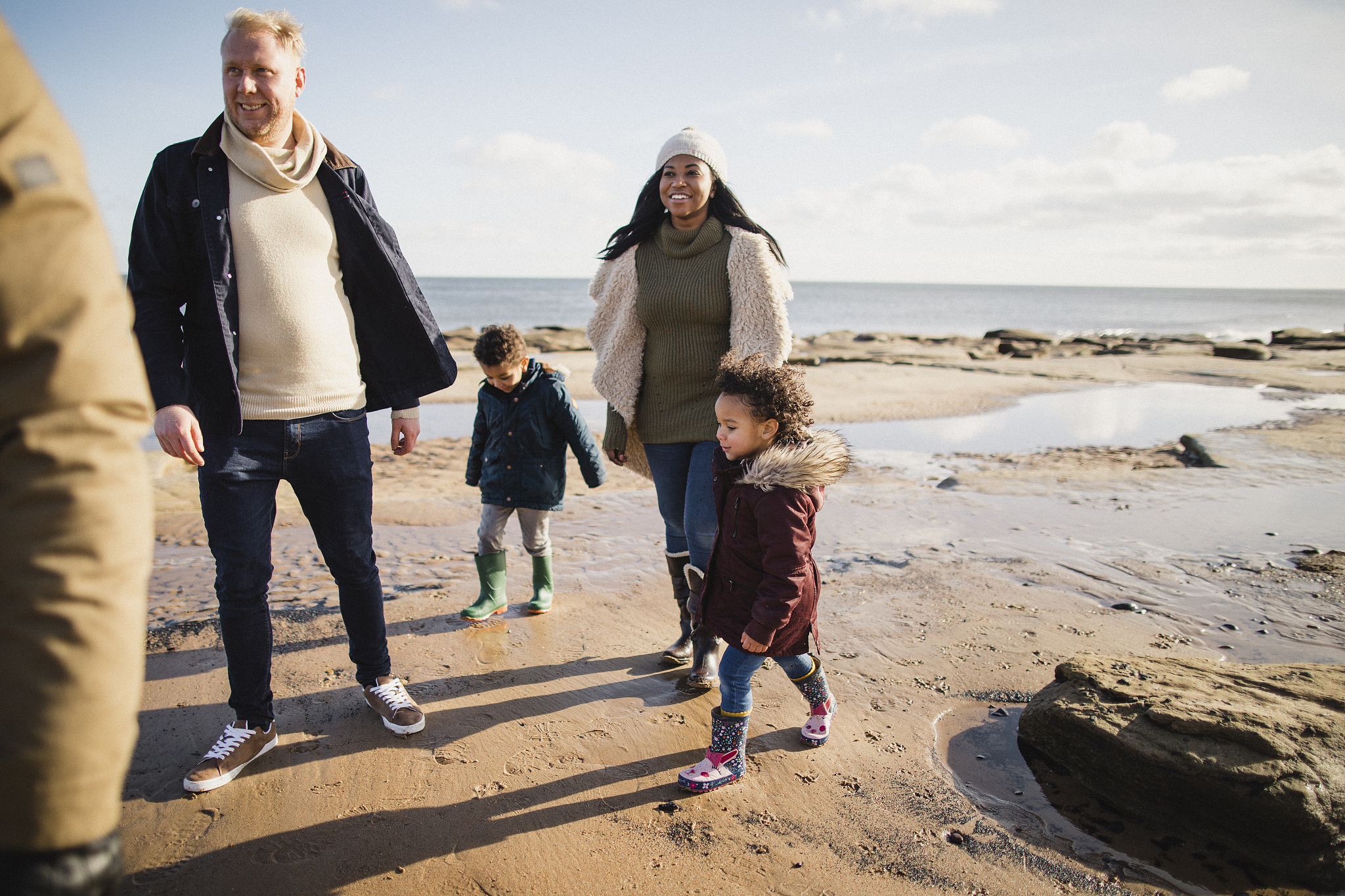 family exploring the beach