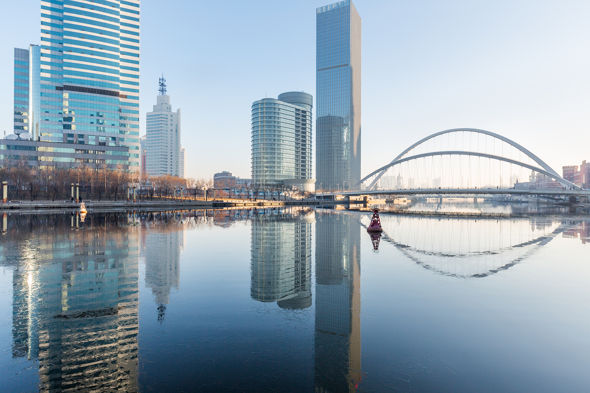 river and modern buildings against sky