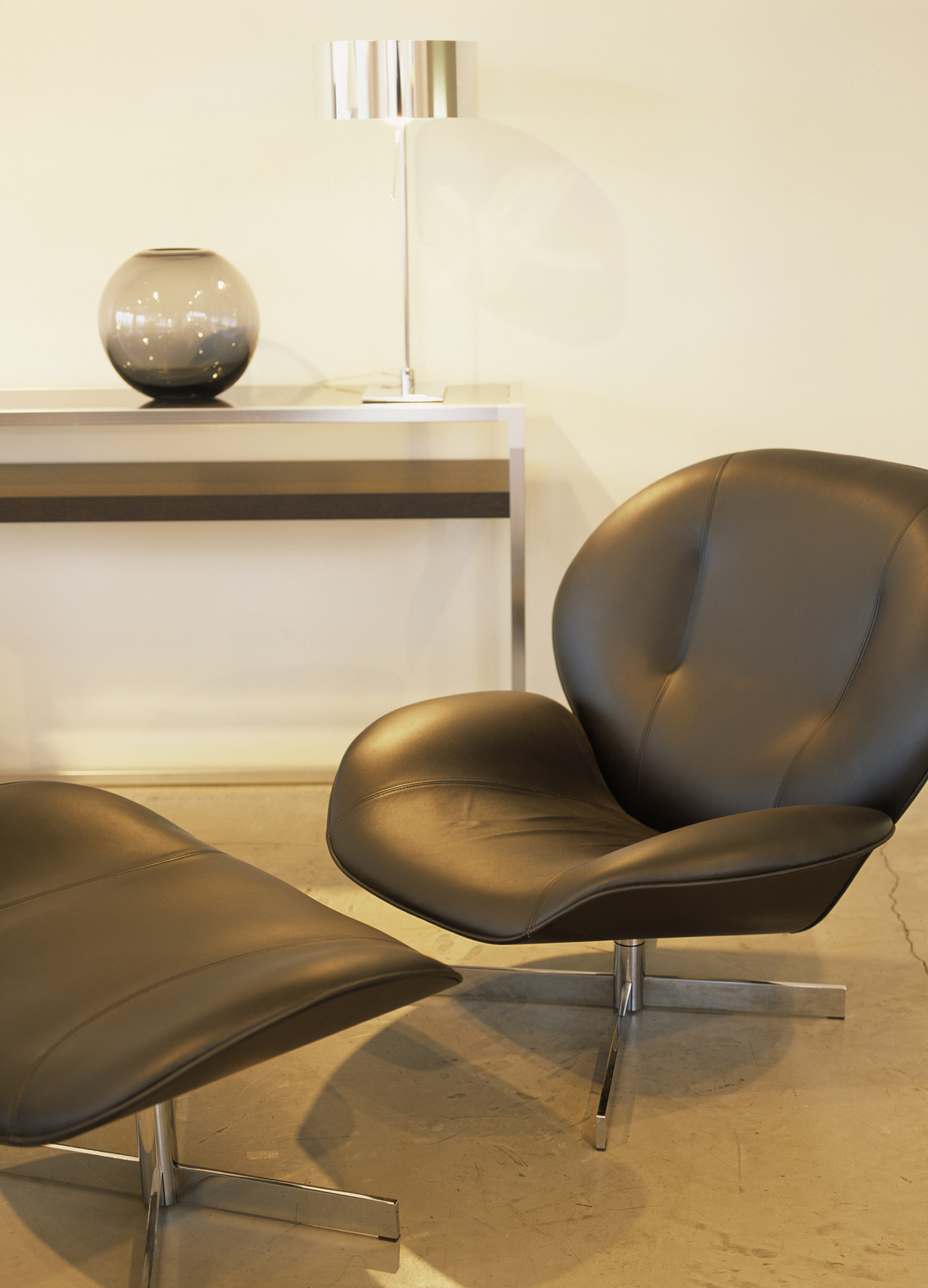 black leather swivel chair with matching ottoman
