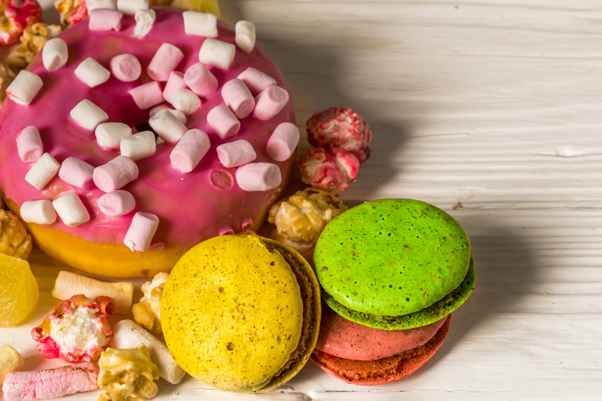 big beautiful pink box with sweets on wooden background