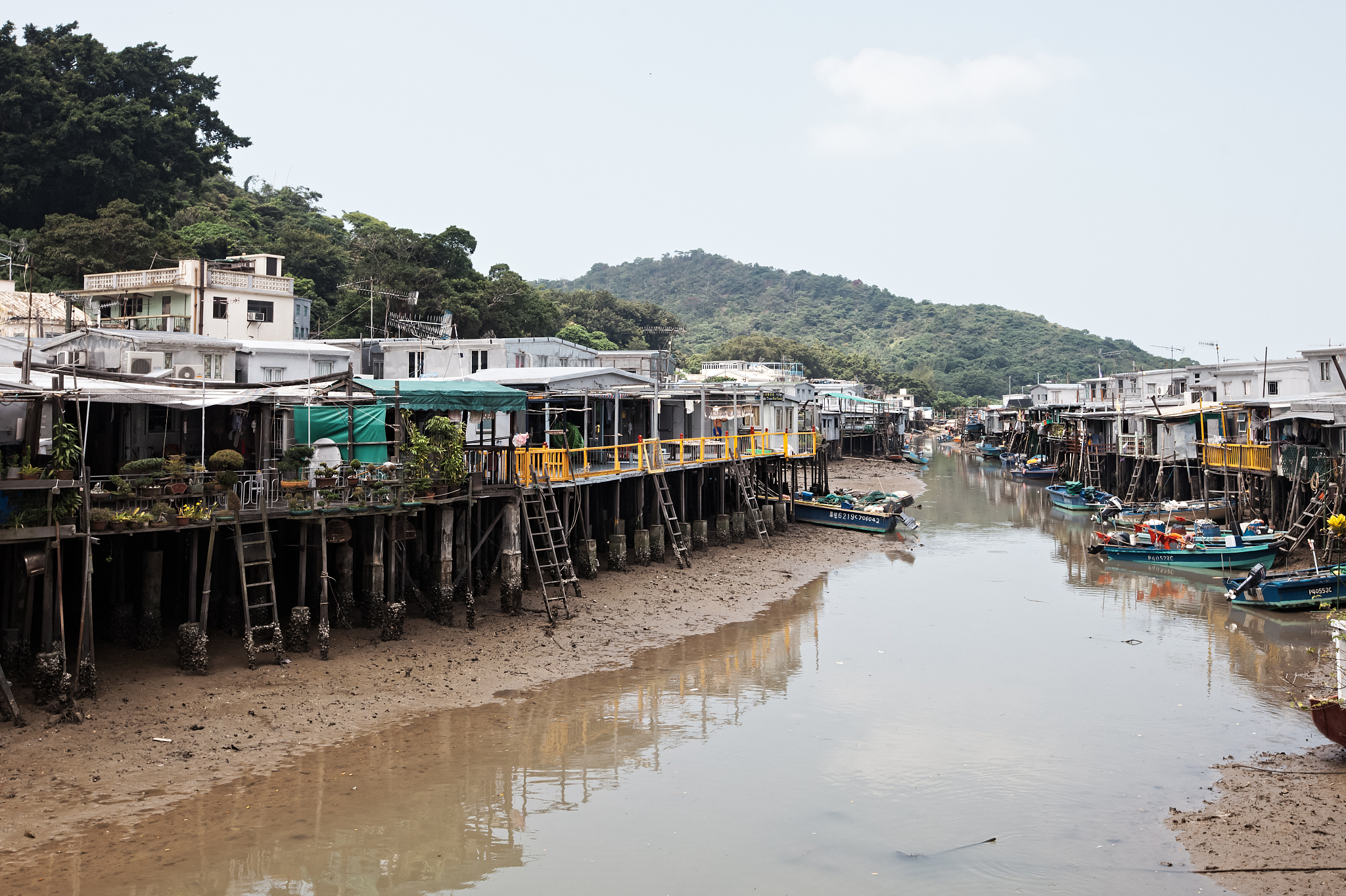 the typical stilts houses with boats anchored nearby them in the