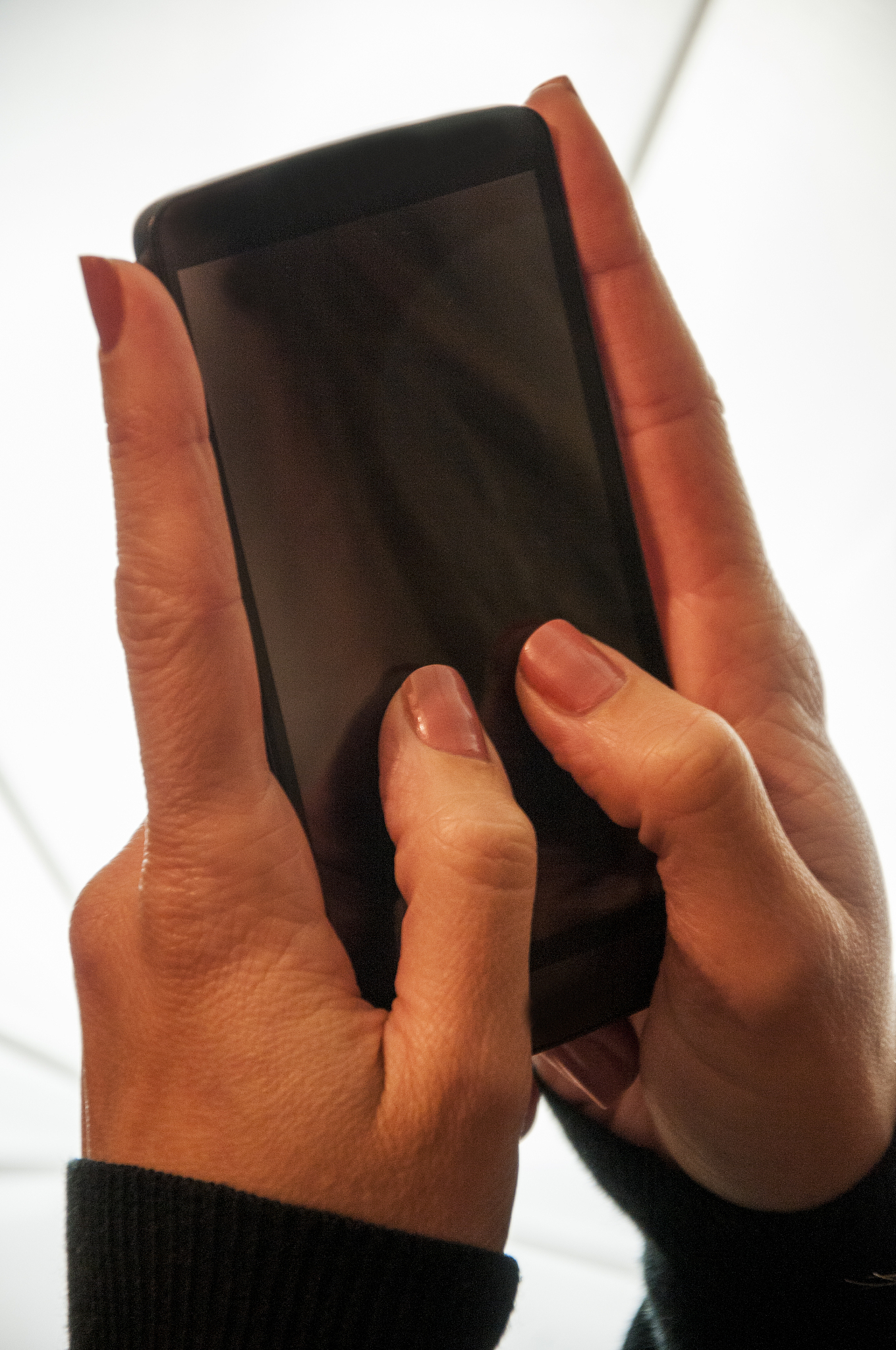 cropped hand of woman using mobile phone