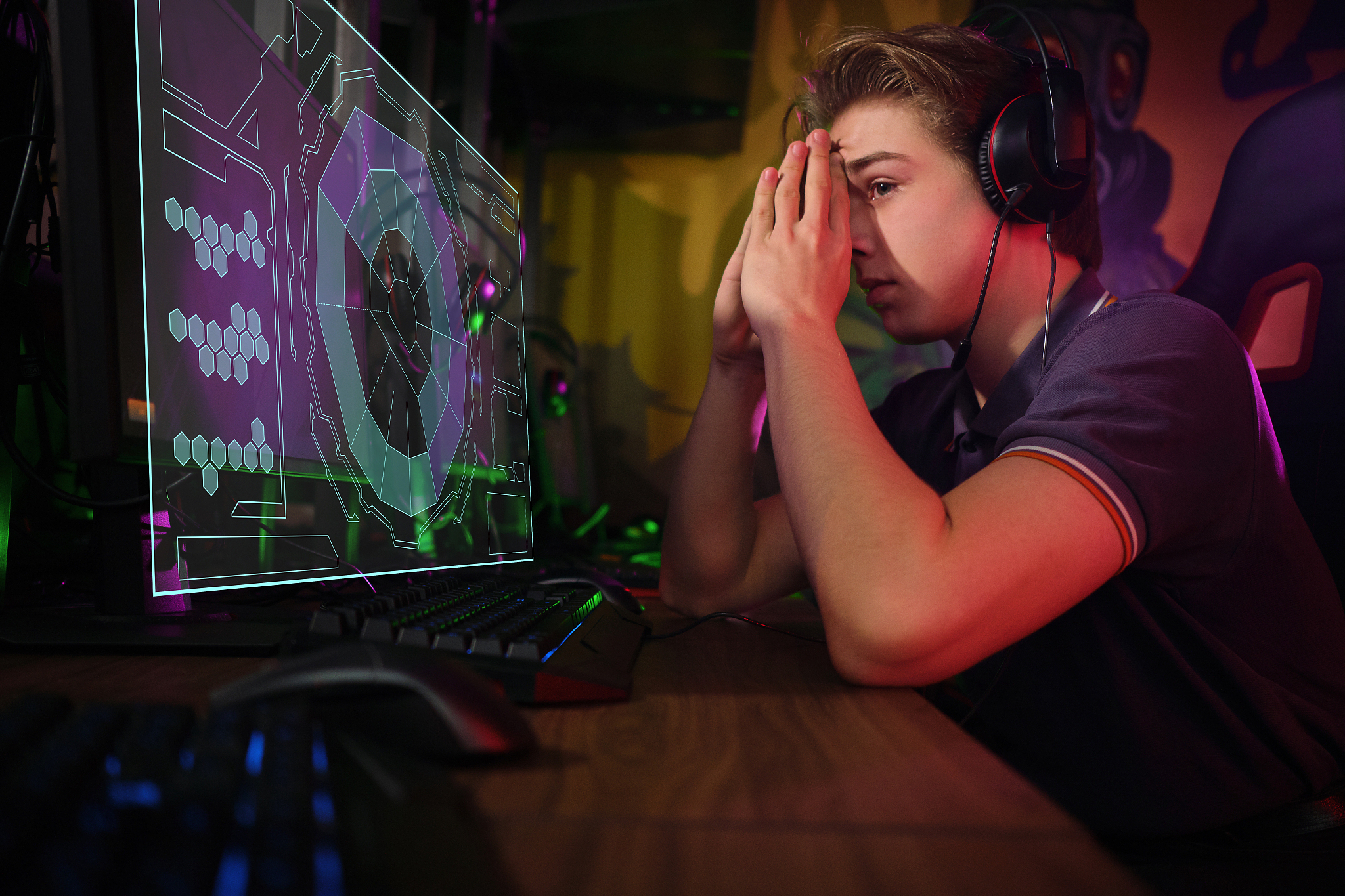 professional young caucasian gamer playing online on his pc. he 