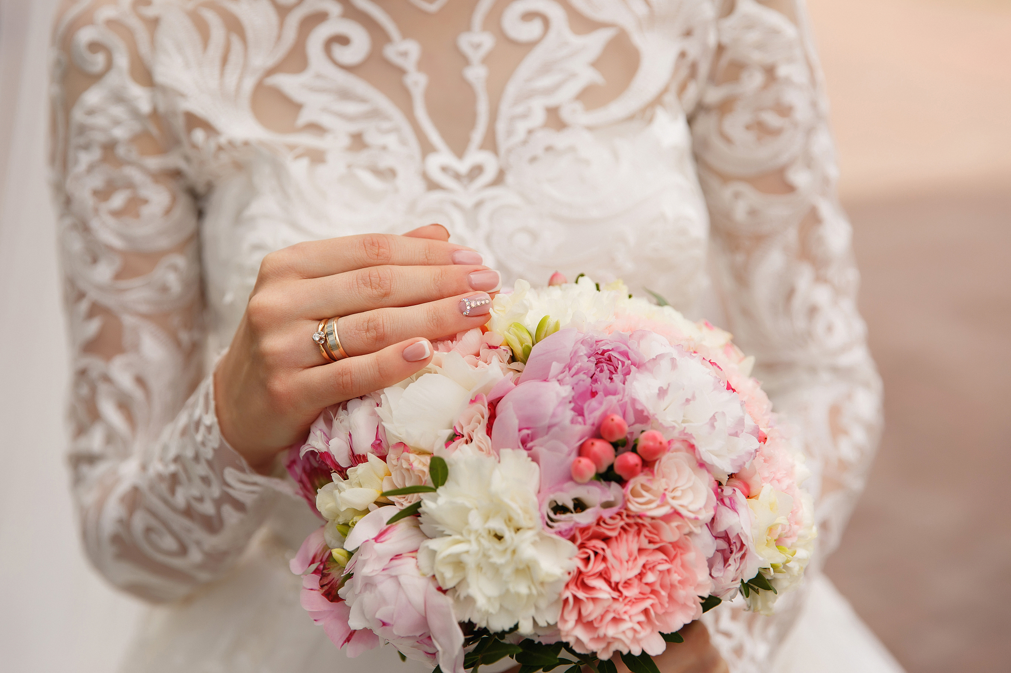 bride with beautiful wedding manicure holding wedding bouquet