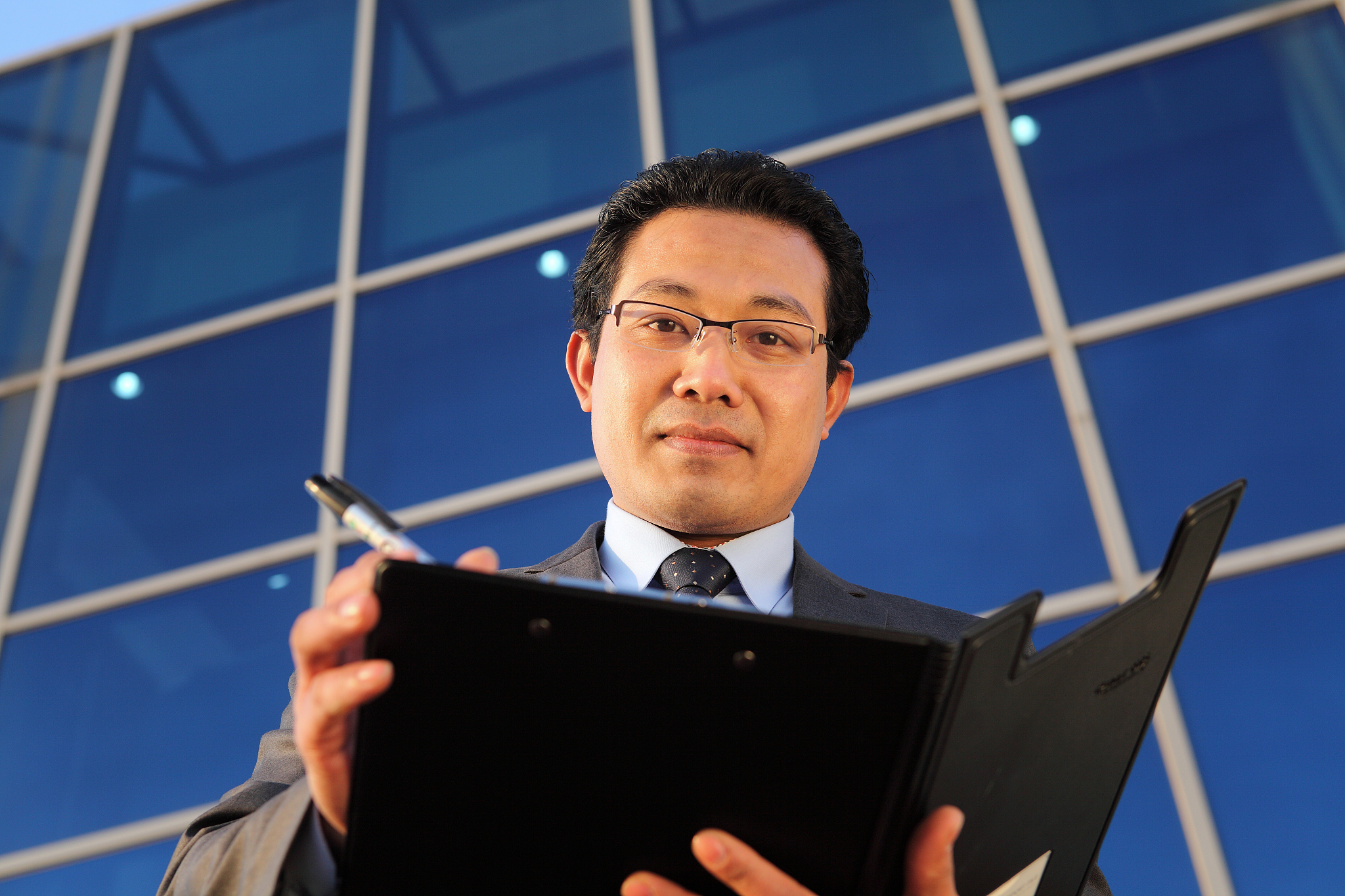 businessman checking paper document look on camera