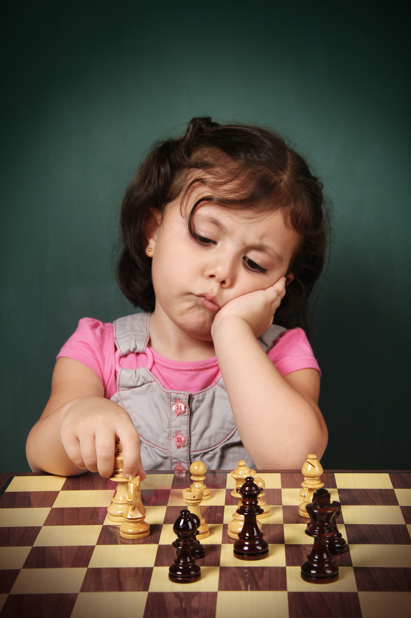 little girl play chess