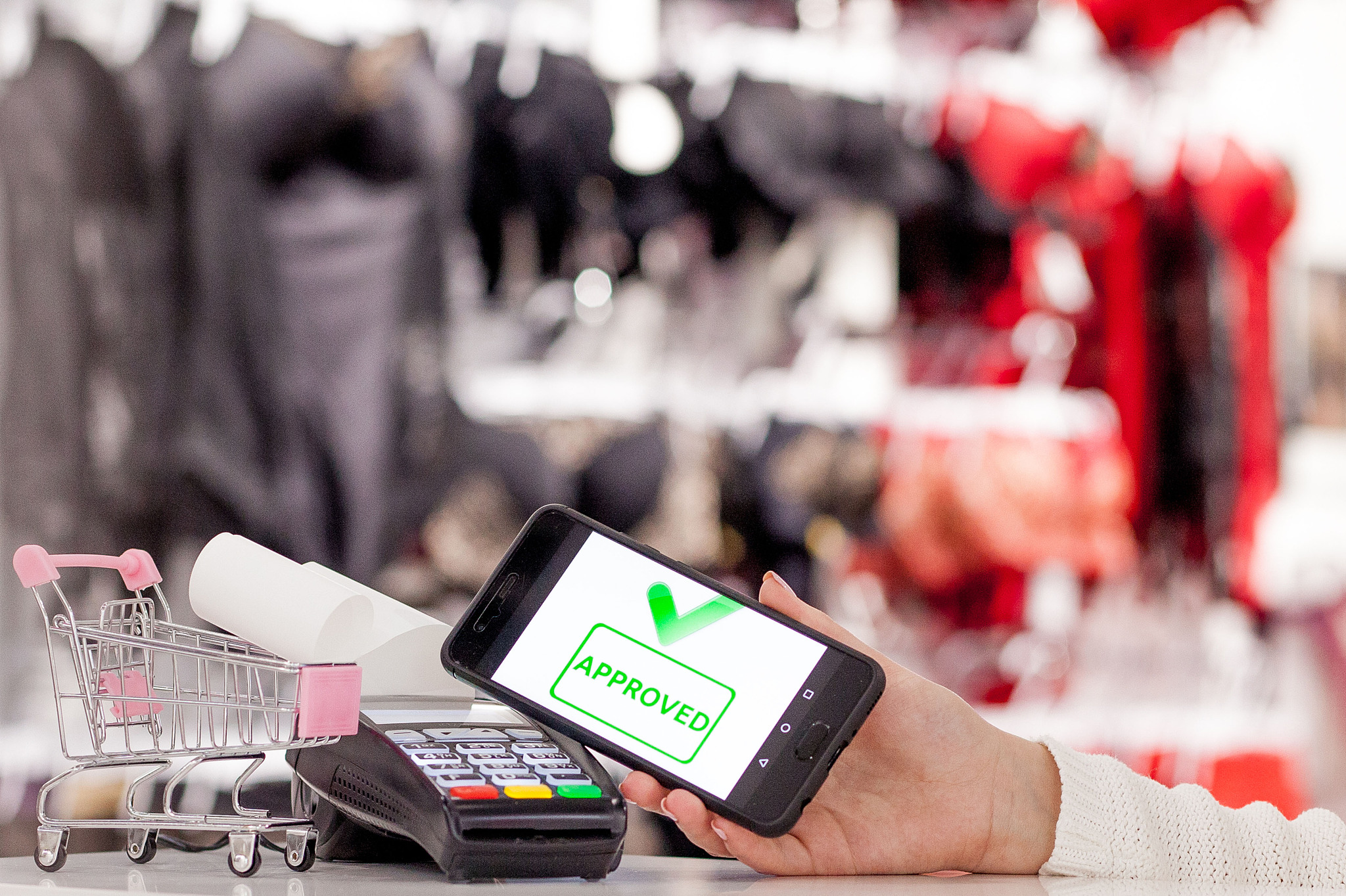 pos terminal, payment machine with mobile phone on store backgro