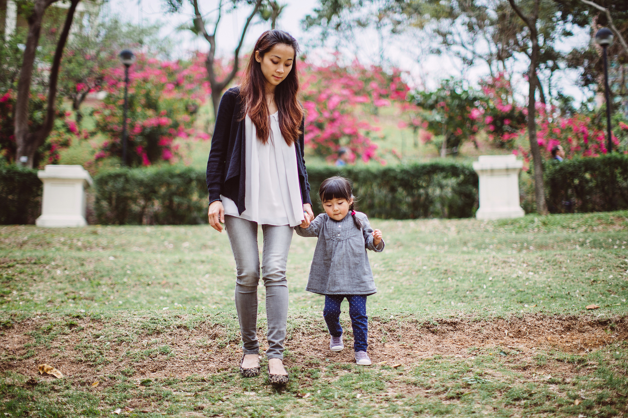 mom & little girl strolling in the park