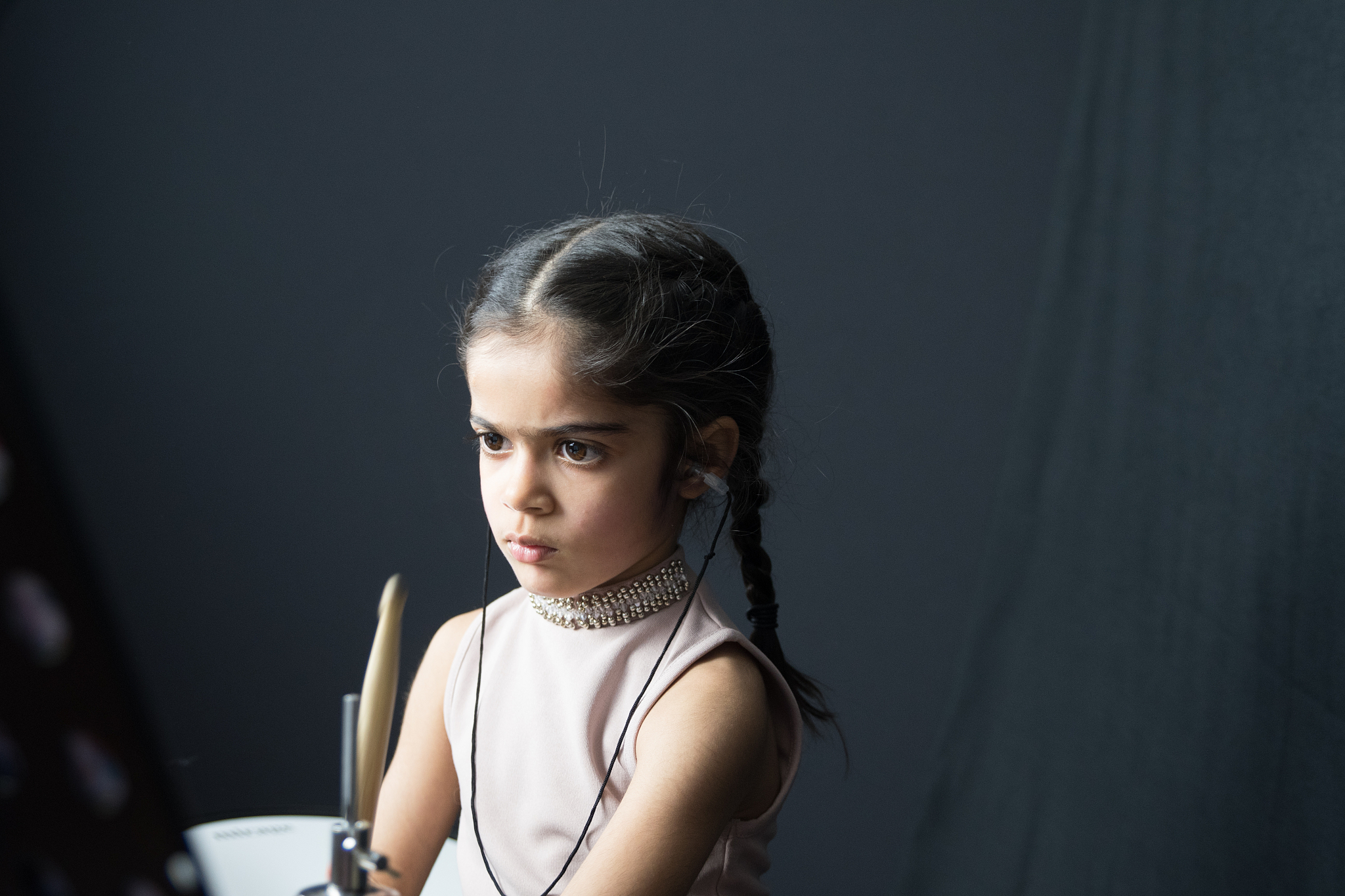 5 year old girl practices the drums
