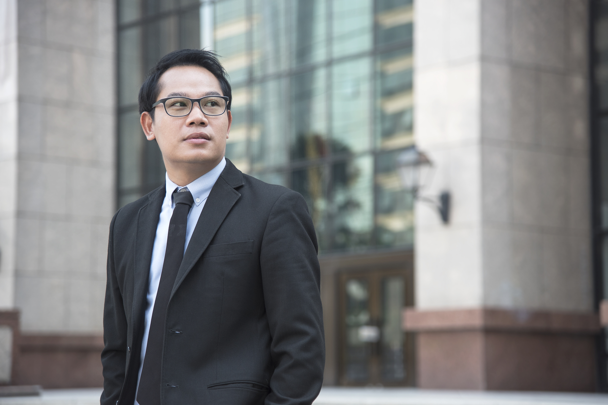 portrait young asian businessman handsome looking for something.