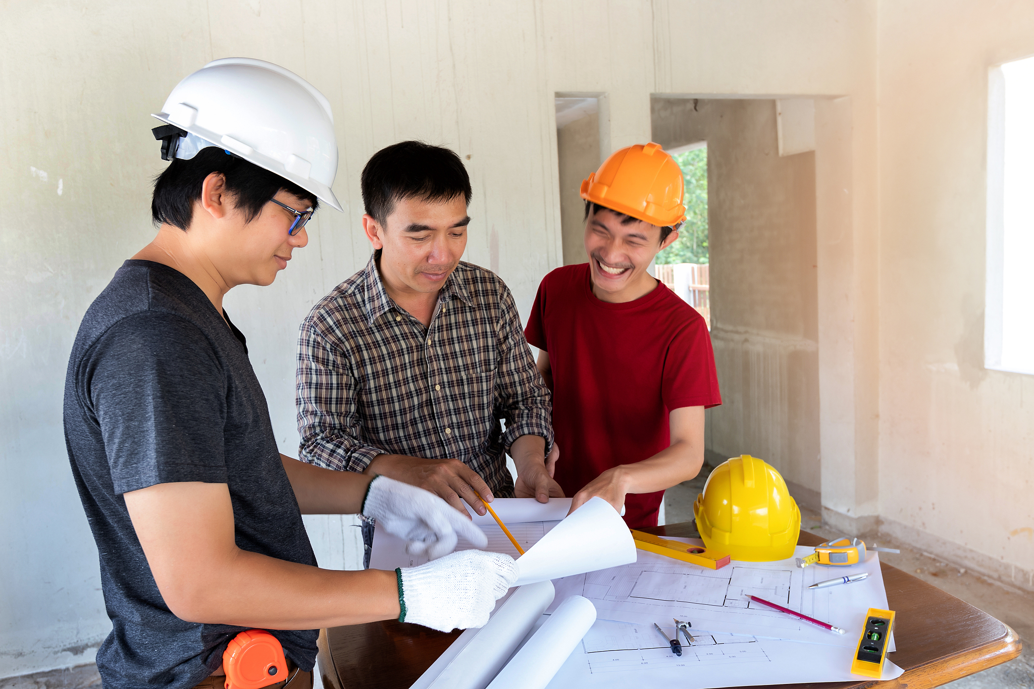 engineer and architect discussing with foreman about project in 