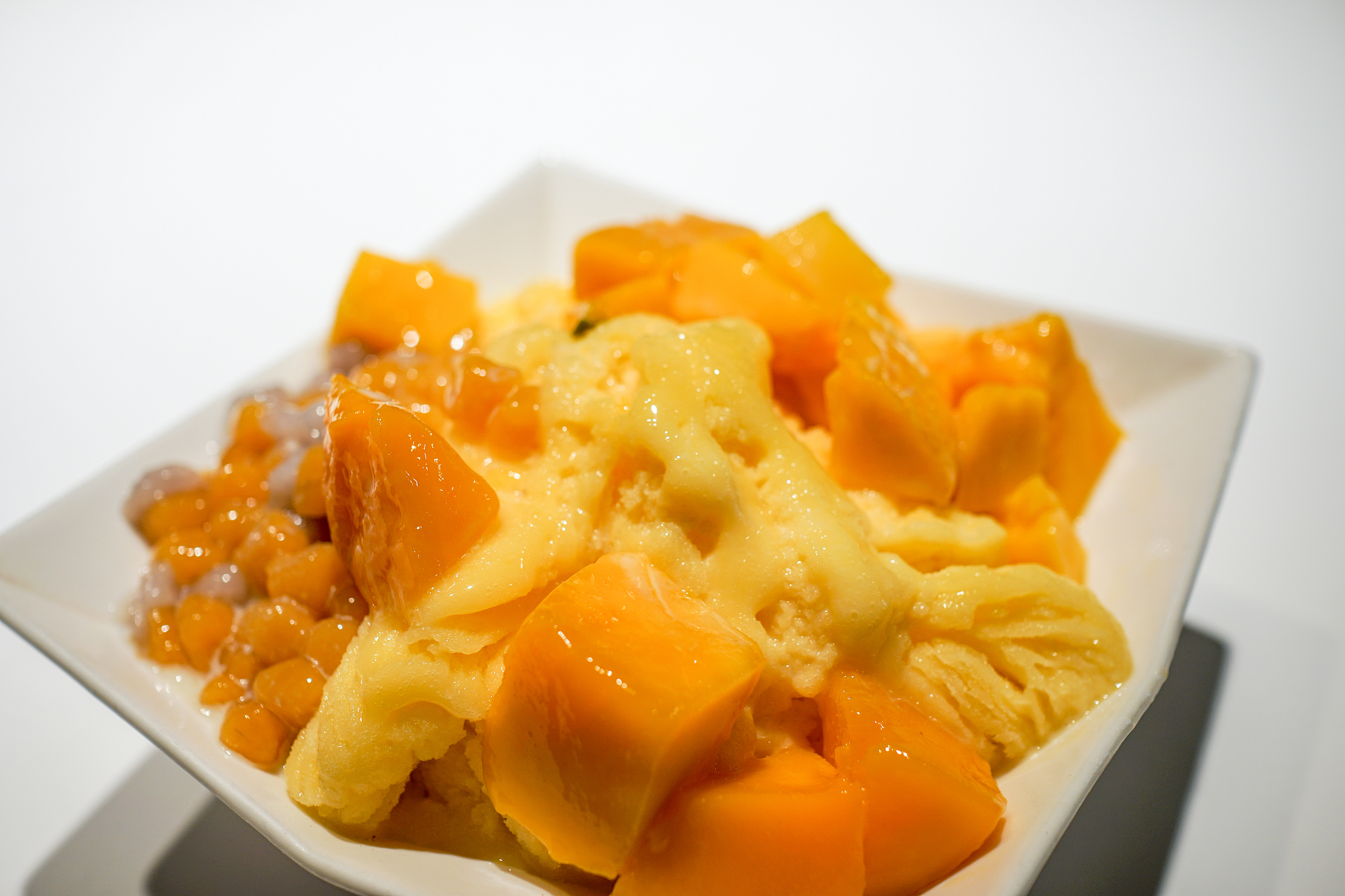 fresh mango with ice cream in the restaurant. close up.