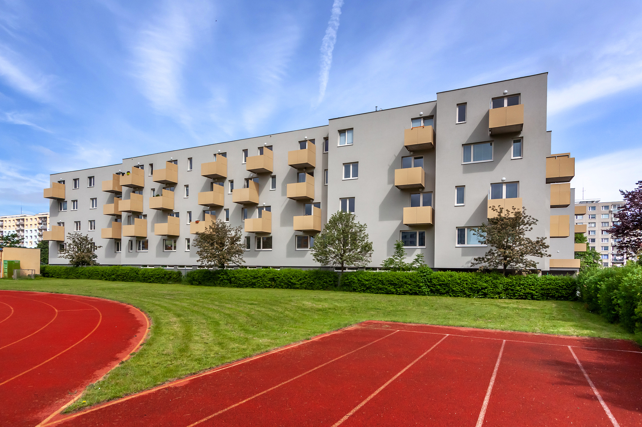 a large brick building with a athletic track