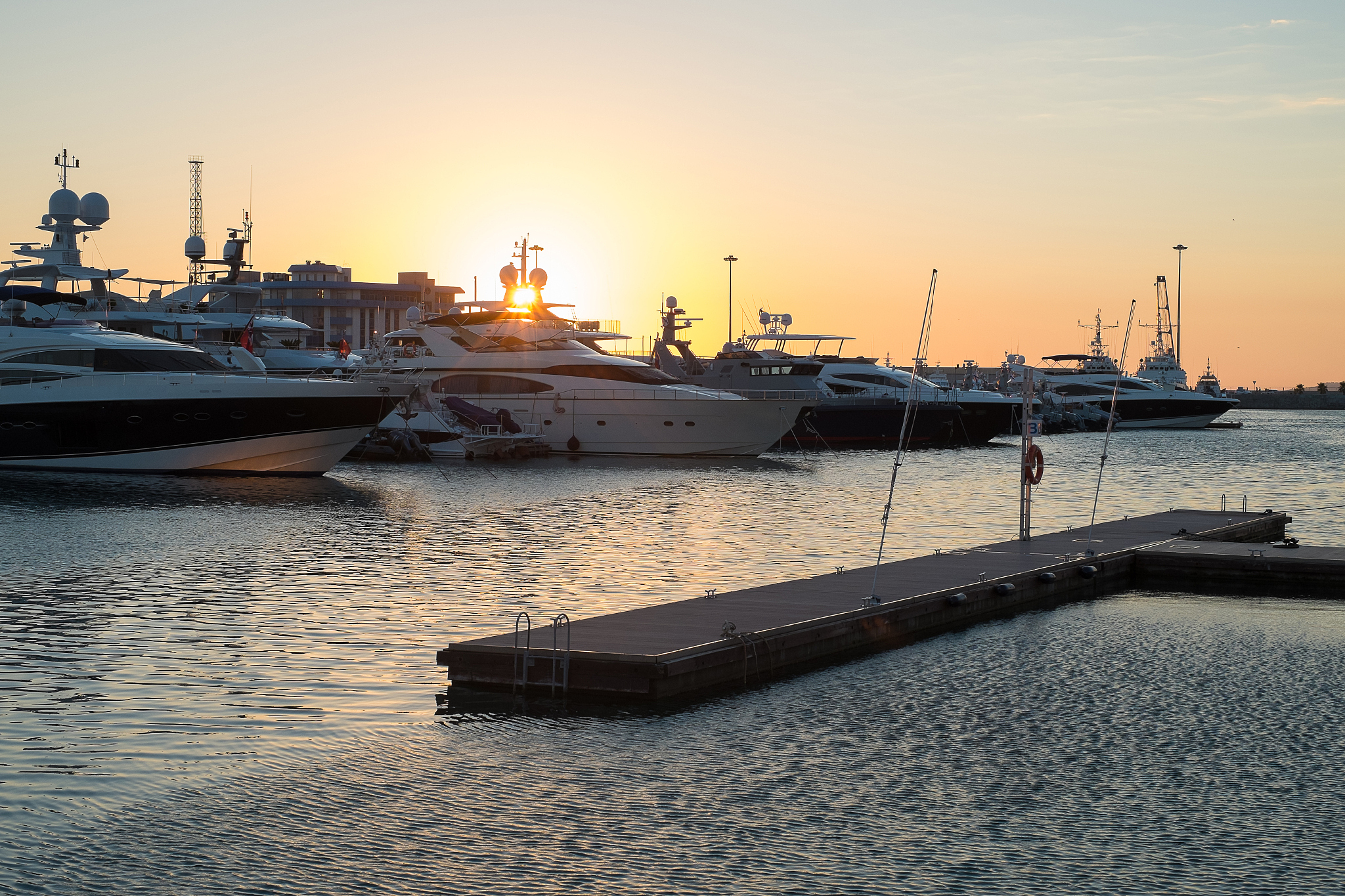 yachts in a port at  sunset