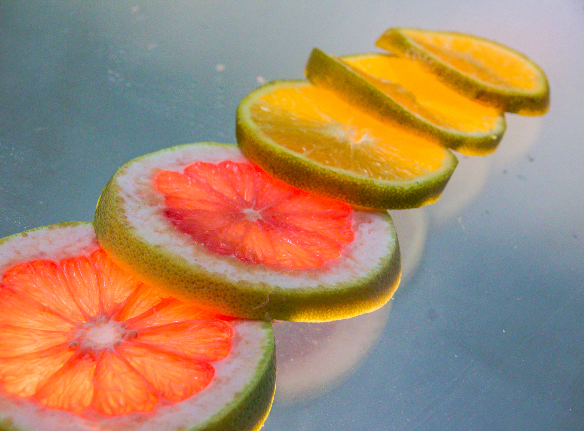 grapefruit and orange slices photograph on lighted glass