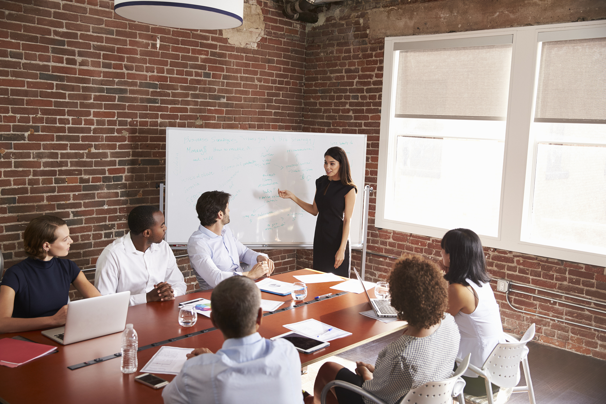 young businesswoman addressing boardroom meeting